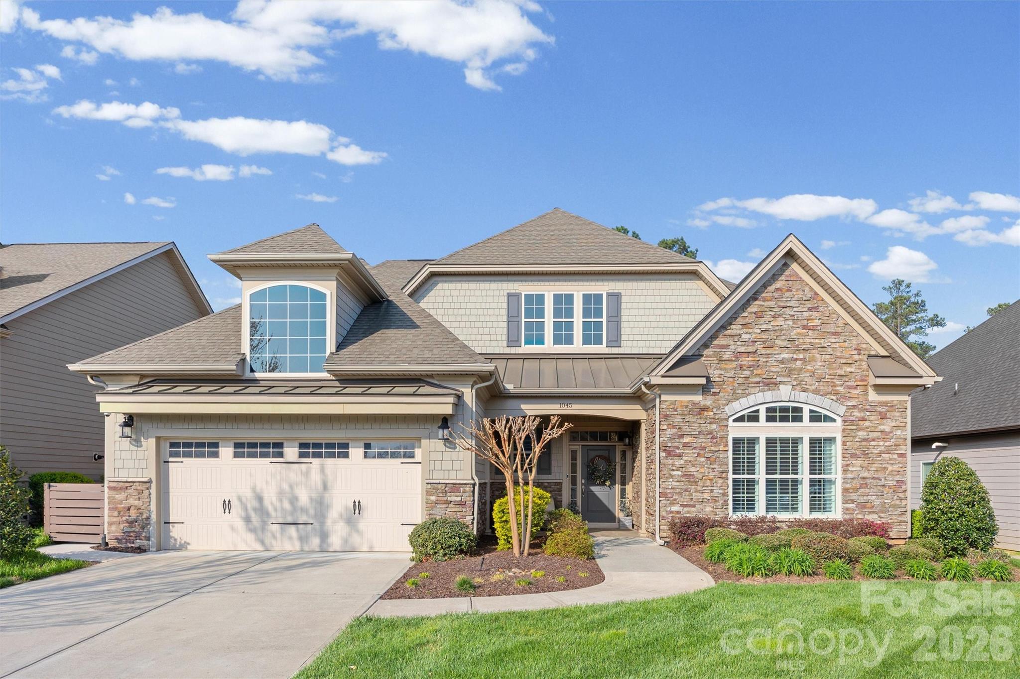 Absolutely Gorgeous Former Model Home with Stunning Outdoor Living! This beautifully appointed residence showcases exceptional craftsmanship, thoughtful design, and upscale finishes throughout. From the moment you step inside, you’re welcomed by an elegant entryway accented with timeless wainscoting and rich hardwood flooring that extends throughout the main area of the home, primary bedroom and bonus room. The stunning kitchen is both stylish and functional, featuring white shaker cabinetry, quartz countertops, gas range, oven and microwave combo, stainless steel appliances, a spacious breakfast area, and an oversized pantry with custom shelving. Everyday convenience is elevated with a thoughtfully designed drop zone and expansive laundry room. The main-level primary suite offers a luxurious private retreat with a tray ceiling, spa-inspired bath with a large tiled shower, and custom walk-in closets with built-in shelving. The main floor also includes an additional bedroom and a private office with built-ins, offering flexibility for guests, multigenerational living, or working from home. The backyard is truly an entertainer’s dream. Enjoy the covered porch with automatic screens, extensive travertine pavers, a built-in bar with grill and refrigerator, and a stunning wood-burning stone fireplace. Beautiful waterfall features complete the space, creating a private, resort-style outdoor oasis. With designer details, premium upgrades, and the distinction of being a former model home, this exceptional property and neighborhood offers luxury living at its finest.