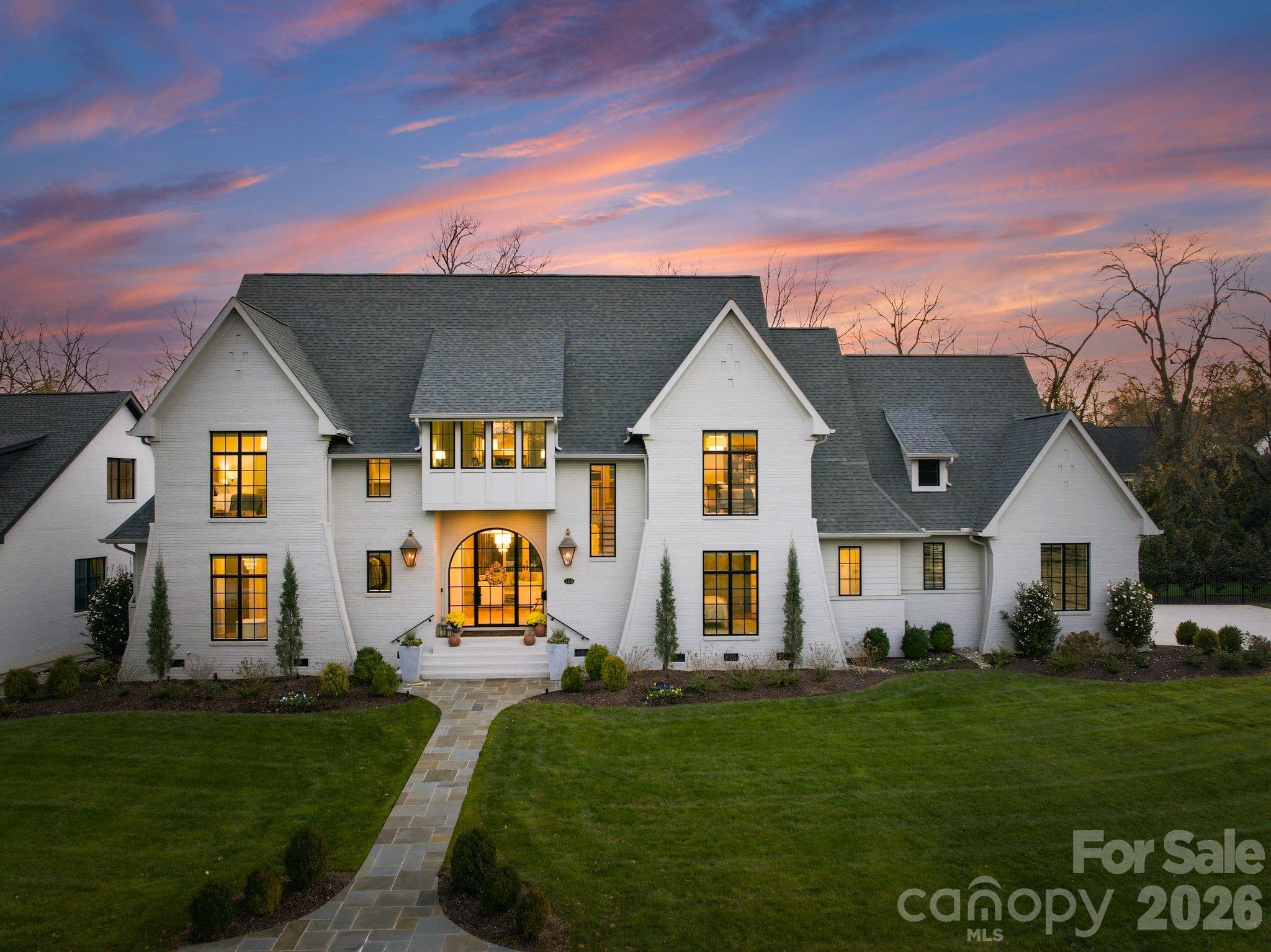 Welcome to an extraordinary estate in the heart of Myers Park, where refined architecture and modern elegance converge. A grand, light-filled interior unfolds through an expansive open floor plan, anchored by a main-level primary suite and private guest retreat, each designed with a sense of quiet luxury. The primary sanctuary is complemented by a spa-caliber bath, featuring a sculptural soaking tub, marble walk-in shower, dual vanities, and an impeccably designed bespoke dressing room.
The culinary space is both striking and functional, centered around a statement white oak island with luminous quartz surfaces and appointed with a suite of professional-grade appliances by Thermador, Wolf, and Sub-Zero. White oak floors extend throughout, while soaring vaulted and coffered ceilings, tailored millwork, and curated designer lighting create a layered and sophisticated aesthetic. Walls of glass invite abundant natural light, enhancing the home’s seamless flow and sense of scale. Upstairs, four beautifully appointed bedrooms are complemented by a private study, media lounge, and a flexible fitness or wellness space. Designed for elevated living and effortless entertaining, the covered outdoor terrace features a built in grill, beverage refrigerator, ice maker, fireplace, and integrated heating for year-round enjoyment. The grounds have been transformed with animal friendly turf, a 90-foot in-ground heated saltwater, Pebble Tec, Infinity edge swimming pool, surrounded by sandblasted textured marble and exquisite fire bowls adding a touch of elegance. Home equipped with a WHOLE HOUSE GENERATOR and fully integrated with a Control4 smart home system, offering a seamless and intuitive living experience. Welcome Home!  Please see attached features for complete list of extraordinary details!