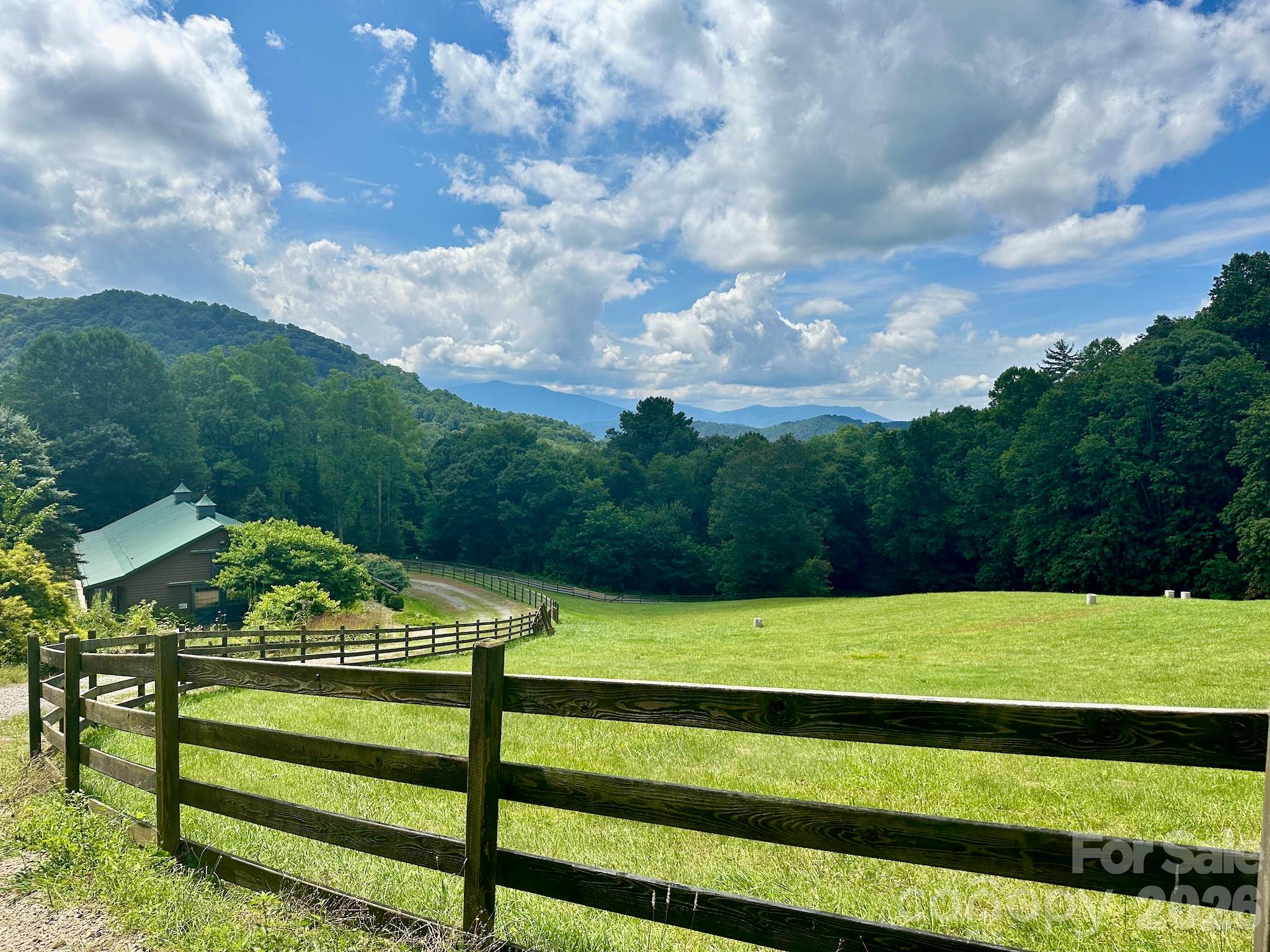 Welcome to your future home site in the picturesque Wolf Creek Ranch community, nestled in the heart of Haywood County. This 3.17-acre lot offers stunning, unobstructed views of the majestic Western North Carolina landscape.

As you explore the property, you'll first encounter the Mail Barn, which provides convenient storage for packages and a secure, gated entrance. The lot features private gravel road access and electricity access boxes at road, making it ready for your dream project.

Your new home will be perfectly situated across from a charming community gazebo, complete with seating, a fire pit, and beautifully maintained landscaping, all set against the backdrop of a classic barn.

Located just an hour from Asheville Regional Airport and downtown Asheville, you'll have easy access to the city's renowned restaurants, vibrant art scene, craft breweries, and a wealth of outdoor activities.