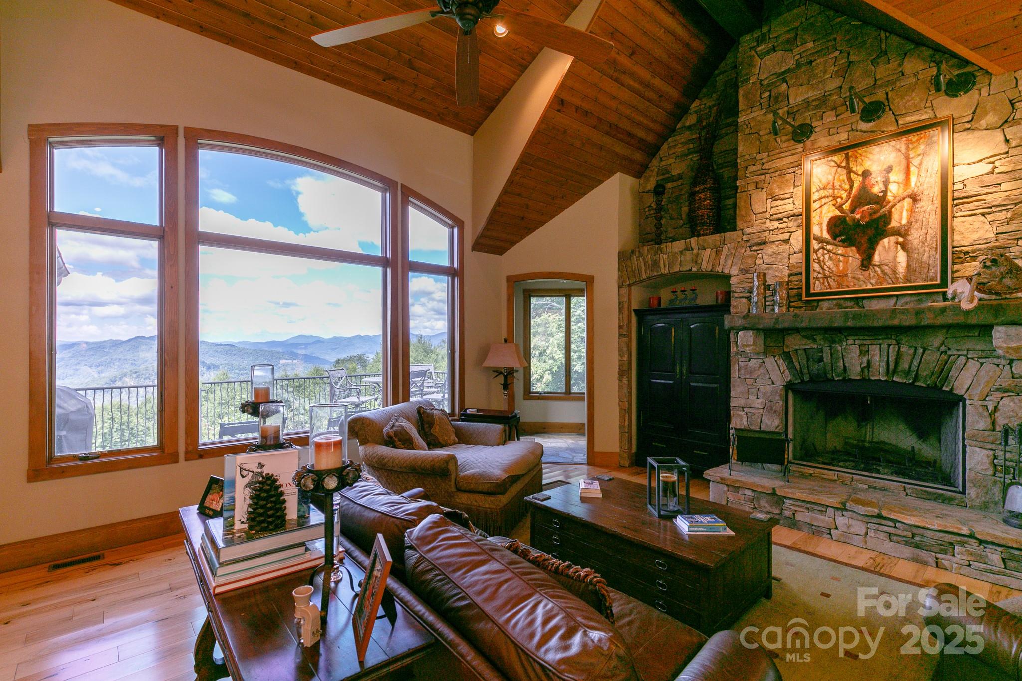 This stunning MOUNTAIN AIR home with 4 BR 3.5 BA, on 2.68 acres makes a lasting first impression! The open floor plan has soaring ceilings, rustic wood beams & beautiful hardwood floors. Stone masonry & custom woodwork in the great room, fireplace, & built-ins, as well as the amazing Chef’s kitchen. The great room offers large windows for fabulous long-range views & gives access to an impressive, screened deck with pine ceilings, stone floor & stone fireplace. 1700+ sq ft of porches & decks! A dedicated office nook off the kitchen, powder room, and laundry room with drop zone are some great main floor features. Owner acquired two surrounding homesites for added privacy.  Primary BR with stone FP, luxury en suite bath. Downstairs den with kitchen/bar, 3 BR, 2BA, & an AMAZING addition of family/game room with cedar walls! A beautiful open staircase features custom wrought iron railing. FURNISHINGS NEGOTIABLE. Club amenities available with membership include golf, dining, fitness, more.