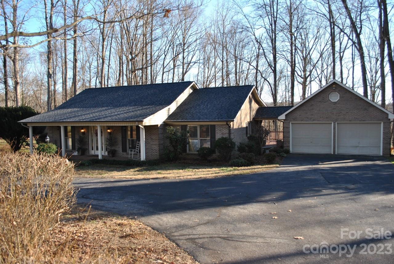 Rocking chair front porch and circular driveway. Quiet neighborhood  nestled in the county yet close to shopping, restaurant, and interstates. This 3 bedroom, 3 1/2 bath BRICK HOME is move in ready! Large kitchen with custom cabinets, tile countertops, tile floors, and cooktop island. Built in desk and plenty of storage areas. The laundry room also has built-in cabinets with a half bath.  Entering the foyer  are french doors to the dining area. There is a large den with hardwood floors and fireplace. Basement has tile floors and built-in cabinets too. A full bath is in the basement with an extra unfinished storage area and closet. Sliding doors leading to the patio. Enjoy entertaining under the covered patio or enjoy the sunsets from large back deck. Beautiful home! This home will not last long! Make your appts today!!