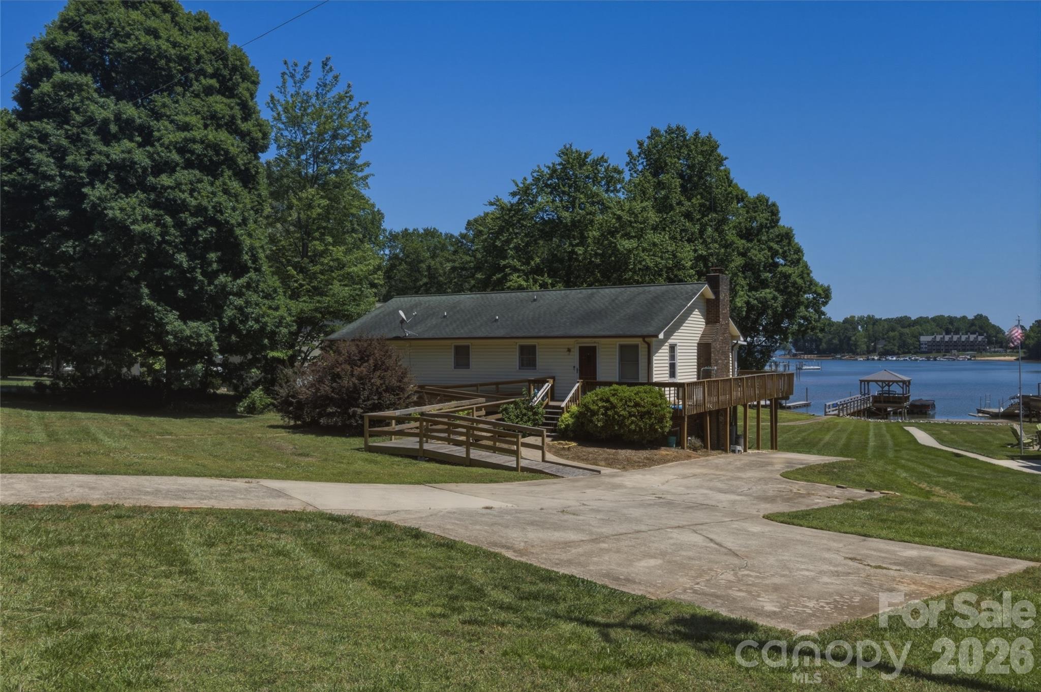 Bring your toolbelt or your architect to the shores of highly desirable Lake Norman! This rare waterfront property in Denver, NC, sits on nearly half an acre of prime, gently sloping land and is ready for its next chapter. Whether your vision is to completely renovate the existing home or start fresh with a custom luxury build, the true value sits in this rare, high-potential lot. Shared private dock allowing for direct access to the lake will have you on the water in no time! Book your showing today, the lake is waiting on you!