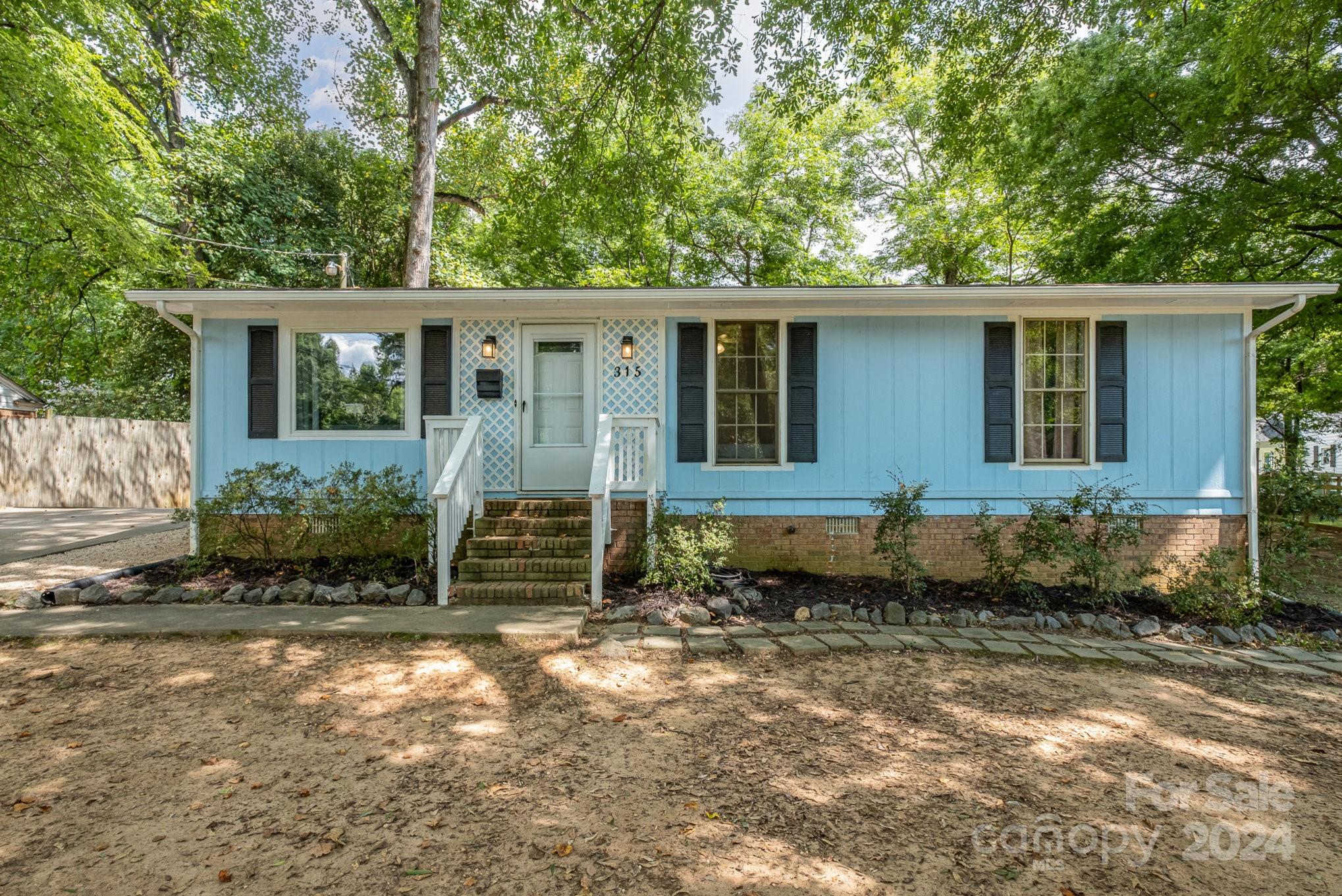 Priced below appraisal!  You are sure to love this adorable and unique ranch home located in downtown Fort Mill. This 3-bedroom 2-bath home is minutes from Walter Elisha Park and Harris St. Park and conveniently located near I-77
This home has spacious bedrooms a large kitchen with new lower lever cabinets.  This home also has 2 unique storage buildings that were previously used as a craft studio and teen get-away.
The home is located on a private corner lot with mature trees with an outdoor home gym in the backyard that can be removed if requested. There is also a 3rd bathroom with shower outside the home. Primary bathroom is not permitted. Motivated Sellers. BACK ON MARKET NO FAULT OF SELLER.