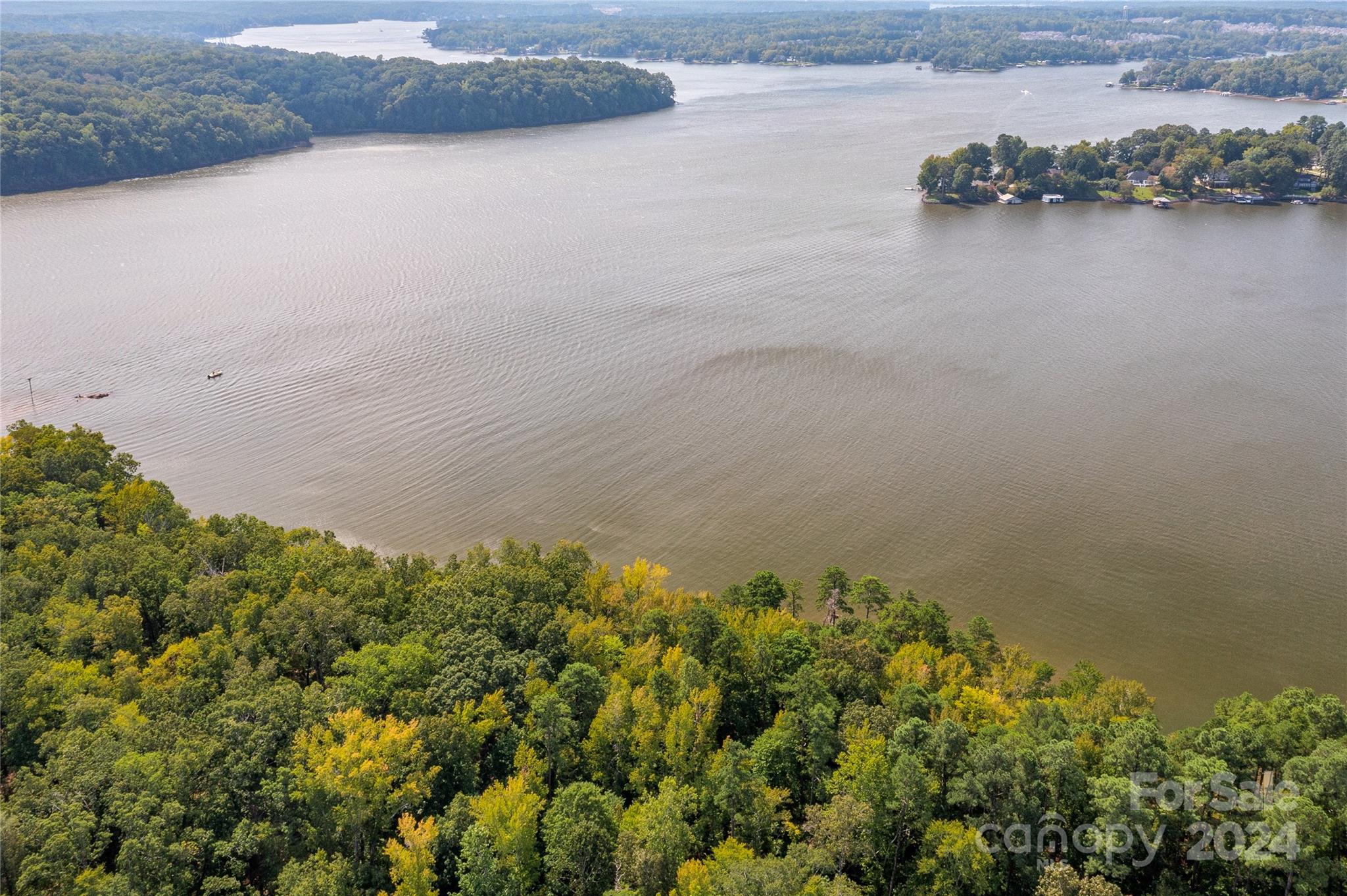 Waterfront and dockable homesite in McLean South Shore in Belmont NC on Lake Wylie. Homesite 12 at 1007 Kingbird Lane, Clover South Carolina is located on western edge of the main channel with views south. The homesite catches west and east views as well! An incredible homesite indeed! McLean South Shore offers walking trails, clubhouse, outdoor pool, fitness center, playground. Drift restaurant within walking or golf cart distance. The Carolina Thread trail along Lake Wylie located across New Hope Road. Within minutes of grocery shopping - Publix and Harris Teeter. Plus minutes from the walkable City of Belmont with its quaint vibe, festivals, park, playground, active train line - kids love watching the train, restaurants and shopping. The bustling Charlotte Douglas airport is about 15 minutes away for easy travel access. Uptown Charlotte, South Park and Ballantyne are commutable via nearby highways. Great small town location at doorstep of a bigger city! Premier waterfront community!