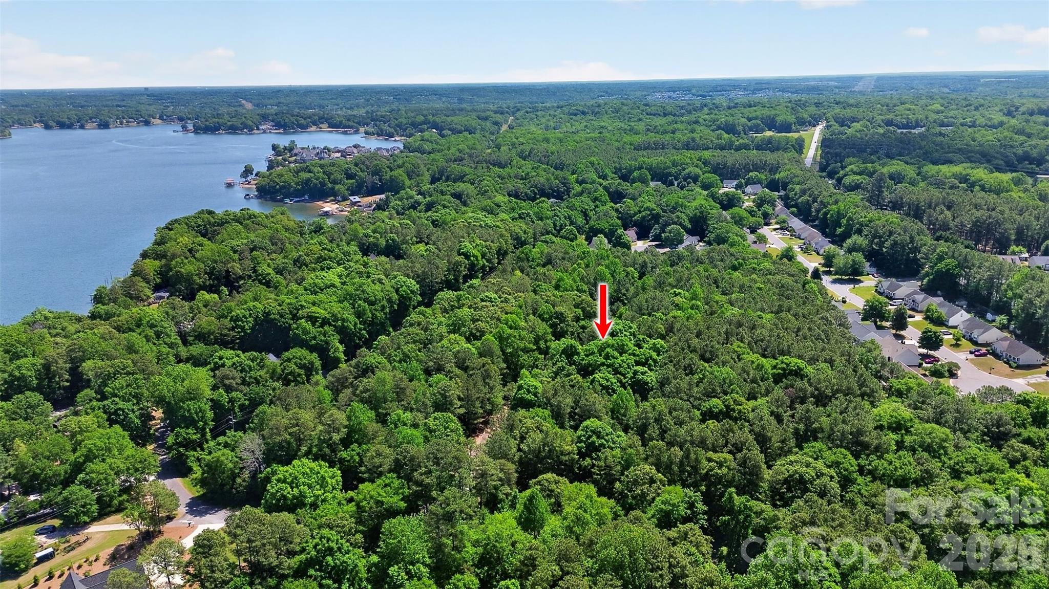 Create your custom retreat on this level, wooded 1.40-acre homesite just across from Lake Wylie. Thoughtfully positioned within a boutique community of only six homes, this lot stands out with its level topography and private setting off the main road. The property has already been perk tested for a 5-bedroom home, making it ready for your vision to come to life. With no HOA and thoughtful deed restrictions in place to maintain like-kind properties, you can enjoy both flexibility and long-term value. Conveniently located near I-77, this location offers easy access while still feeling private and serene, with Ebenezer Park just about a mile away—offering a popular access point for boating, camping, and fishing on Lake Wylie. A rare opportunity to create your own retreat in a well-located, intimate community.