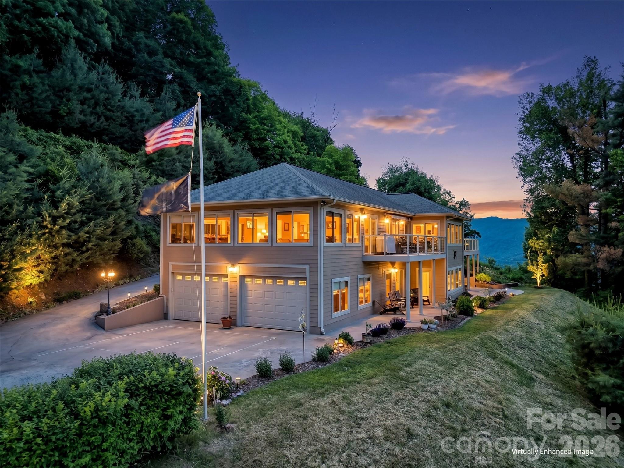 Perched high above the valley in one of Waynesville’s most established and desirable mountain communities, this exceptional custom home offers a rare opportunity to experience true mountaintop living where breathtaking long-range mountain views surround you, yet downtown Waynesville is only three miles away. 
Designed to showcase the beauty of Western North Carolina from nearly every angle, this remarkable residence is filled with expansive windows, soaring ceilings, and an open, light-filled floor plan that seamlessly blends luxury, comfort, and timeless mountain elegance. Every detail has been thoughtfully selected, creating a home that feels both impressive and inviting. 
At the heart of the home is an extraordinary chef’s kitchen featuring custom maple cabinetry with integrated appliance panels for a refined, premium appliances, an oversized granite island and countertops, abundant workspace, and exceptional storage, perfect for everyday living as well as entertaining on a grand scale. Just beyond, an awning-covered deck extends the living space outdoors and offers the ideal setting for morning coffee, evening gatherings, and taking in the mountain views. A dedicated gas hookup makes outdoor grilling effortless. 
The dramatic sunroom is truly a showpiece, featuring vaulted ceilings, walls of windows, and a cozy gas fireplace that creates a warm and inviting retreat in every season. 
The luxurious primary suite serves as a private sanctuary, complete with its own gas fireplace, electric window treatments, and a spa-inspired bath designed for relaxation, featuring a steam shower for a true at-home retreat experience. 
Additional spaces continue to impress with a private office suite complete with its own bath, ideal for working from home or accommodating guests. The lower level offers two spacious bedrooms, additional bathroom with a beautiful custom design soaking tub and and infrared sauna, and walk-out access to a covered patio creating excellent separation and flexibility for family and visitors. 
Car enthusiasts and hobbyists will appreciate the oversized 703 Sq Ft. four-car garage, while practical features such as a generator, solar panels for improved energy efficiency and utility savings, and a 50-amp service connection add convenience and peace of mind. 
Luxury, craftsmanship, and unforgettable views come together in this one-of-a-kind mountain estate offering an elevated lifestyle where every detail has been thoughtfully designed and every room captures the beauty of the mountains beyond. 
Too many exceptional features to fully capture here this is a home that truly must be experienced in person to appreciate all it has to offer.
