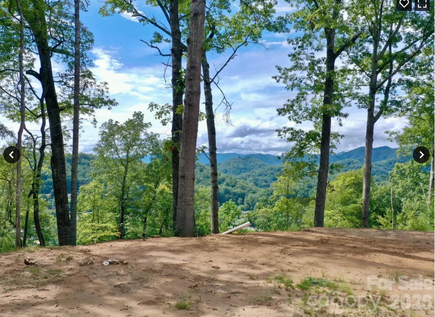 Perched above town, this private mountain retreat is accessed by a short scenic gravel driveway lined with trees, opening up to breathtaking mountain and city views. The elevated setting provides a peaceful, tucked-away feel while still being incredibly convenient — just 2 minutes from Bryson City Bakery, Bryson City Outdoors Brewery, and Pasqualino’s, 3 minutes to the Post Office, Great Smoky Mountains Railroad and Hallmark-like downtown, 5 minutes to Ingles Grocery Store and Darnell Farms and in 10 minutes you are hiking in the Great Smoky’s National Park. World renown white water rafting and the Nantahala Outdoor Center is a scenic 15 minute drive away.

Owners have paved part of the driveway in April 2026.

Every detail has been prepared for your dream build: city water, underground power, and septic are already in place, along with a substantial, professionally installed house pad. This thoughtful groundwork ensures a smooth start to construction, whether you envision a luxurious mountain retreat, an income-generating vacation rental, or your forever home.

It’s the perfect blend of natural beauty, privacy, and easy access to everything Bryson City and the Smokies have to offer.