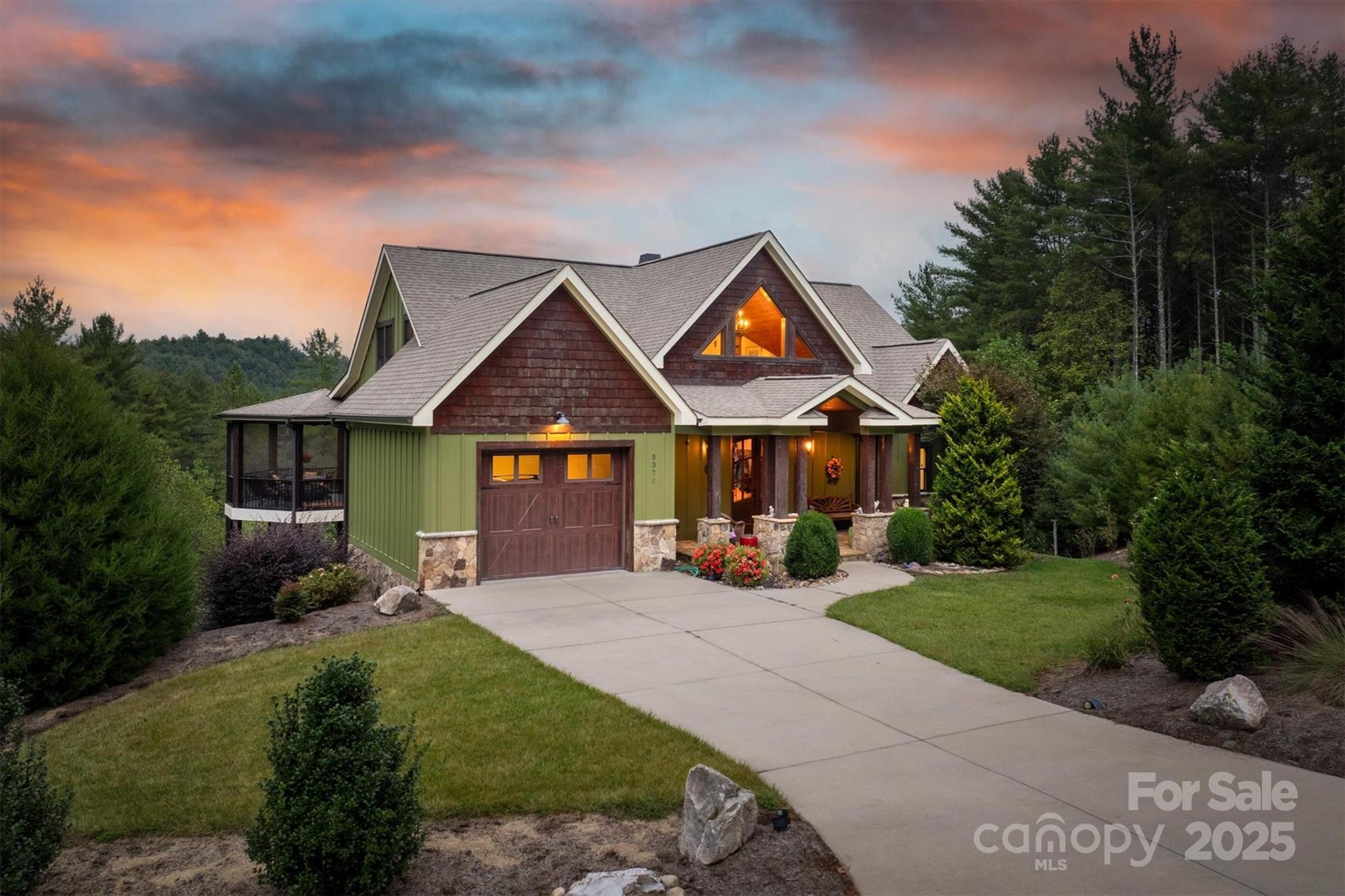 This stunning custom home, crafted by Shaw Custom Builders, blends exceptional craftsmanship with superior construction for the ultimate in mountain living. Built with 2x6 framing for strength, energy efficiency, and durability, the home features artisanal finishes and custom millwork, including elegant bullnose edges throughout for a refined, seamless aesthetic. Spanning over 4,000 square feet, the home boasts an open-concept layout with thoughtfully defined spaces and floor-to-ceiling windows that flood the interiors with natural light and frame the breathtaking views of The Coves Mountain River Club. On the main floor, the primary suite offers a luxurious retreat with a stunning spa-like bathroom and an expansive walk-in closet. The gourmet kitchen features pecan wood cabinets with their distinctive grain patterns, a walk-in pantry for ample storage, and beautiful finishes throughout, while the main floor laundry adds convenience to everyday living. Upstairs, two guest bedrooms with private ensuite baths flank a versatile loft area, ideal for a home office, reading nook, or creative retreat. The lower level is designed for fun and relaxation, with a family/recreation room perfect for game nights or casual gatherings, another bedroom with ensuite bathroom, plus plenty of storage space to keep everything organized. Outdoor living shines with two levels of decks, including a screened-in upper deck for year-round enjoyment, all overlooking the beautiful Blue Ridge Mountain scenery. For outdoor enthusiasts, the home is just steps from trailheads leading directly to the Johns River, offering endless opportunities for hiking, fishing, and exploring nature. Best of all, it’s less than 5 miles from Wilson Creek, 40,000 acres of the Pisgah National Forest, an outdoor sportsman’s dream. Plus, you’re less than 30 minutes from Blowing Rock, Morganton, and Hickory and only 75 minutes from Charlotte International Airport, making this the perfect blend of luxury, adventure, and accessibility. Welcome Home!