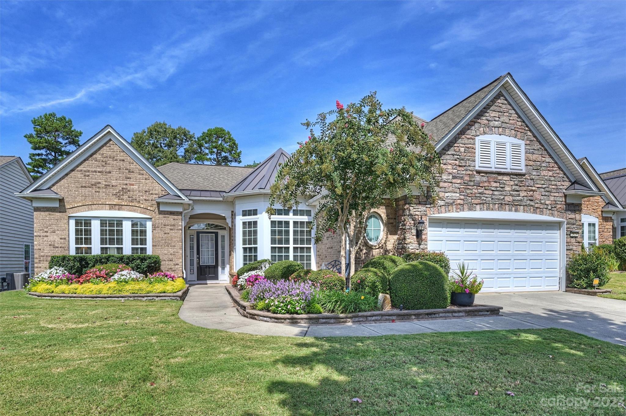 Stunning Cumberland Hall w/Sunroom in sought after Sun City!  Welcome to this immaculate 3 bedroom, 2.5 baths, split floor plan, plus study/den.   New hardwood floors (1/24), including all formal areas, and primary bedroom.  The gourmet kitchen boasts granite, beautiful wood cabinets, stainless steel appliances, wall oven and microwave, pantry and large island plus a breakfast bar.  The open living room has lots of natural light and gas logs in the fireplace for those chilly winter days. The primary suite features large windows, a tray ceiling & ensuite bath w/garden tub, walk-in shower, dual-sink vanity and large walk-in closet.  Two guest bedrooms w/hall access to a full bathroom w/dual vanities. The laundry room offers cabinets and a utility sink.  Enjoy a cup of coffee or an afternoon beverage in the bright and spacious sunroom with the view of a lush, private backyard.  The paver patio is also great for relaxing, or grilling out and enjoying nature.