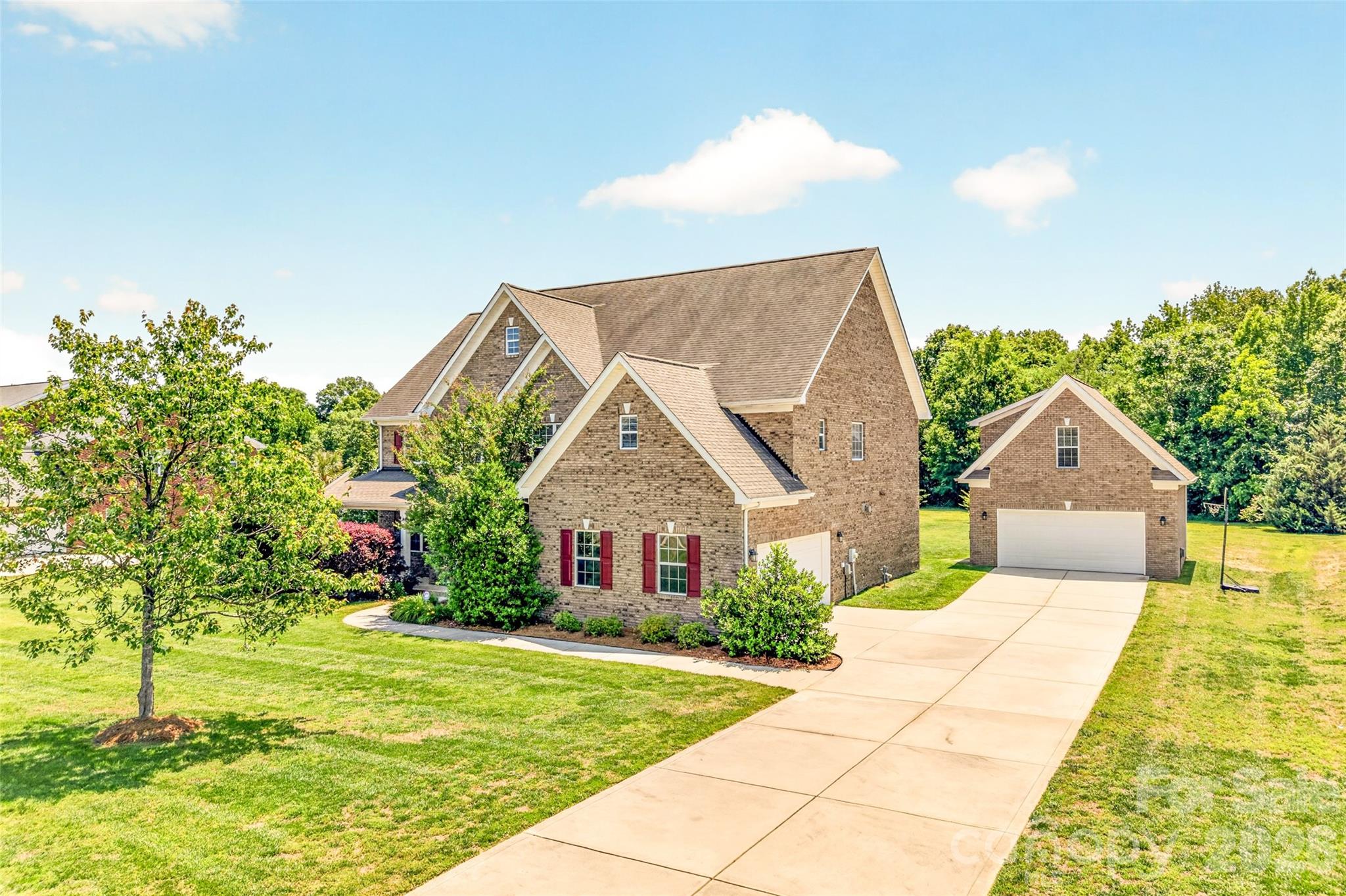 Beautifully maintained full-brick home located in the highly sought-after Wesley Chase community in the Village of Wesley Chapel, part of the greater Matthews area, and within the desirable Weddington school district. Situated on approximately 0.93 acres, this spacious residence offers 5 bedrooms, 4 full bathrooms, and a functional floor plan designed for everyday living, entertaining, and flexible lifestyle needs.

From the moment you enter the home, you are welcomed by a grand staircase leading to the second level along with spacious living areas and abundant natural light throughout. The open kitchen features a center island, ample cabinetry, and flows seamlessly into the den, creating an inviting layout for gathering and entertaining.

The second-level primary suite offers tray ceilings, a spacious ensuite bathroom with separate tub and shower, and an oversized walk-in closet providing exceptional storage and functionality.

One of the true standout features of the property is the detached two-car garage with finished flex space above complete with an additional full bathroom, creating exceptional versatility for a private home office, gym, media room, bonus room, guest retreat, hobby space, creative studio, or additional entertaining area.

The nearly one-acre homesite provides a beautiful and private setting with room to relax, entertain, and enjoy outdoor living. Conveniently located near shopping, dining, parks, and everyday conveniences while tucked away in a quiet neighborhood setting, the property offers an excellent balance of convenience and privacy.

Conveniently located near Matthews, Waverly, Rea Farms, Ballantyne, and Uptown Charlotte, the home also offers excellent commuter accessibility while still enjoying the space and lifestyle that make Wesley Chapel one of the area’s most desirable locations.

Rare opportunity to own a spacious, full-brick home with flexible living space, detached garage with finished flex space, and access to sought-after Weddington schools in a highly desirable Union County location.