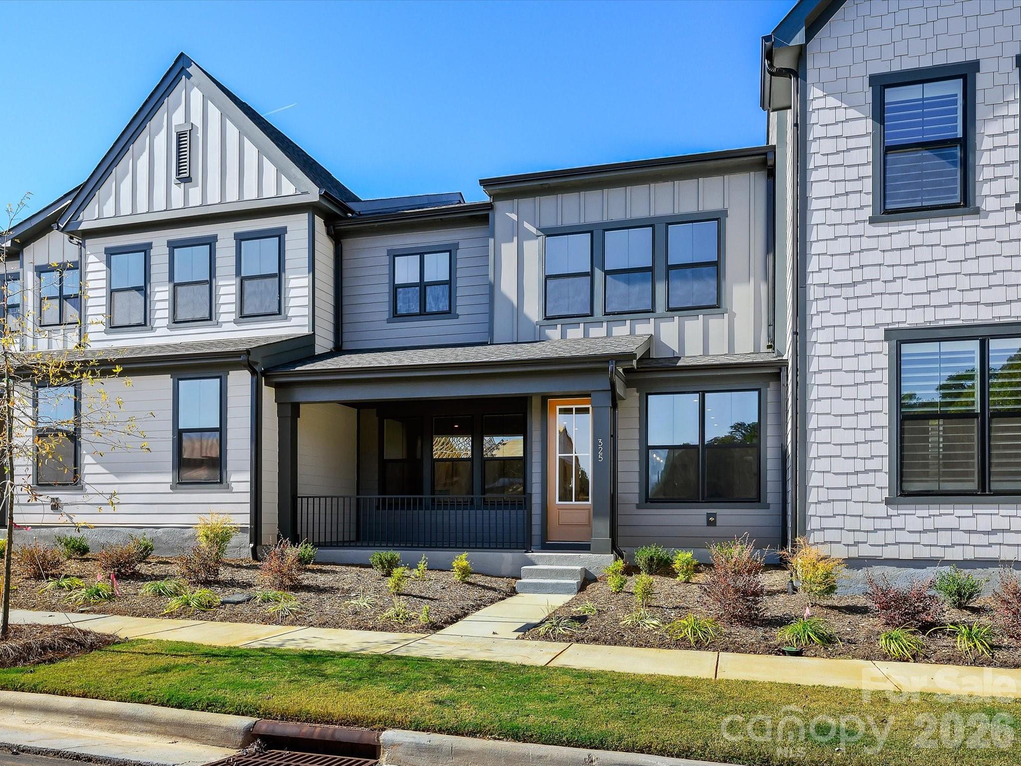 This home delivers a striking blend of sophistication and comfort in one of the community’s most desirable settings. Enjoy open views, abundant natural light, and a peaceful connection to the activity lawn, pavilion, and miles of scenic walking trails just outside your door. Inside, rich dark accents, premium flooring, and airy open spaces create an upscale yet inviting atmosphere. The sleek, two-tone gourmet kitchen is a true showpiece, featuring crisp white cabinetry, dramatic matte black hardware, quartz countertops, and designer pendant lighting. The open rail design on the first floor enhances the home’s bright, flowing layout, making each space feel even more expansive.