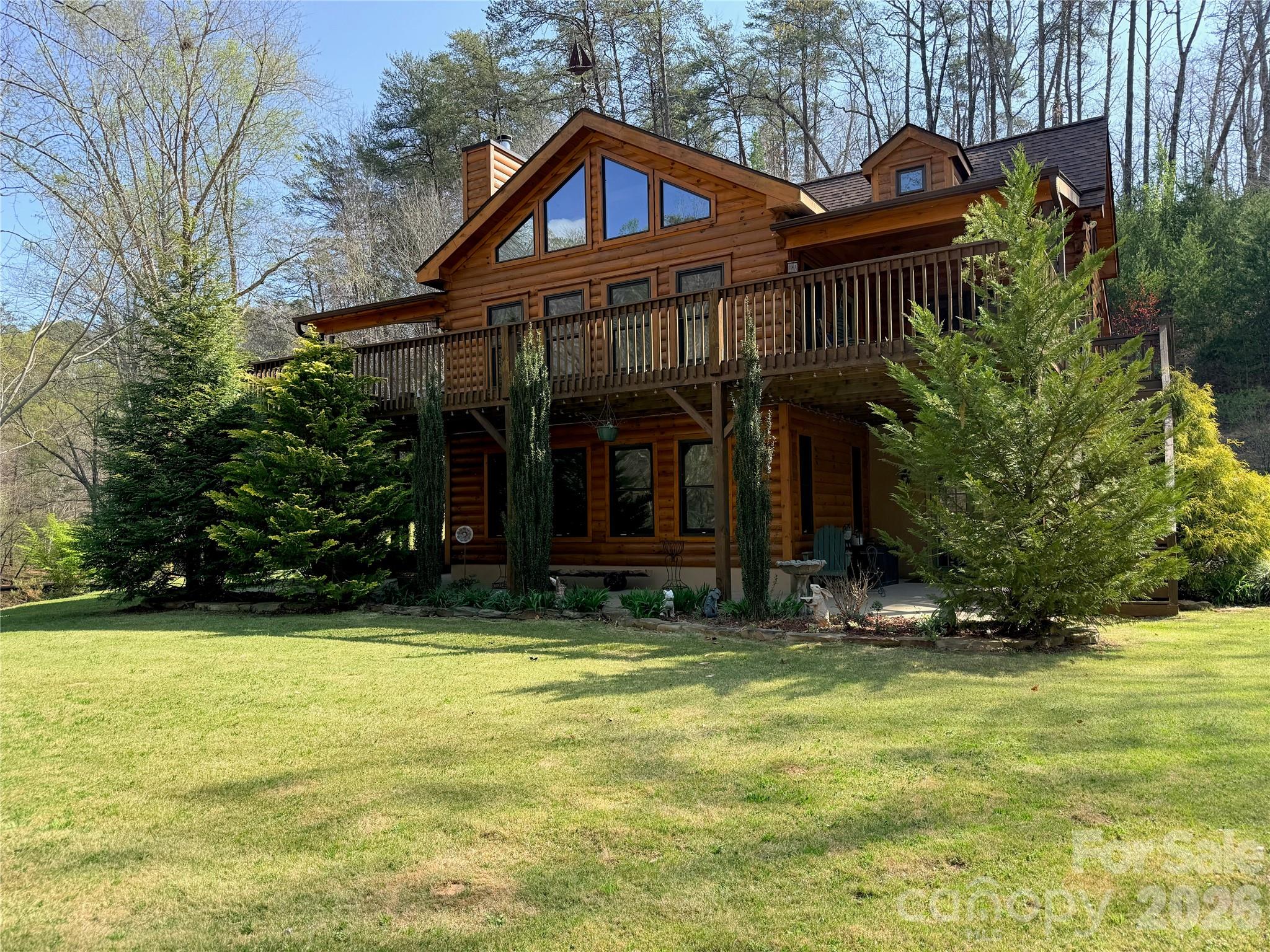 Nestled on 5.38 private acres along the gently flowing Britten Creek, this exceptional luxury cabin estate offers over 4,000 square feet of combined living space across a 4-bedroom, 4-bath main residence Cabin built in 2017 and a beautifully appointed 2-bedroom, 1-bath guest house (cottage) was built in the 1930's. There is also a detached workshop for added versatility. Designed for full-time living, multi-generational flexibility, or income potential, the main home features warm wood flooring throughout, a stunning central fireplace, and a modern kitchen crafted for both everyday comfort and effortless entertaining. A thoughtfully designed lower level with its own exterior access, full bath, and partial kitchen creates ideal space for guests, extended family, or rental use. Perfectly positioned just minutes from Lake Lure, Chimney Rock, Saluda, and Tryon Equestrian Center, this property blends convenience with the privacy of a true mountain retreat.

From the moment you arrive, the setting captivates. Britten Creek gently wraps the property, creating a rare, almost island-like sanctuary, while the surrounding landscape unfolds in soft, elevated contours reminiscent of a private retreat. Inside, expansive windows bathe the home in natural light and frame serene views of water, trees, and mountain air beyond. Step onto the covered porch or deck and let the sound of the creek slow the pace of your day, inviting rest and reflection. Whether hosting in the guest house, creating in the workshop, or simply enjoying the quiet beauty around you, this is more than a home—it’s a place where nature, craftsmanship, and lifestyle come together in perfect harmony.

Schedule your private showing and discover the lifestyle waiting for you.