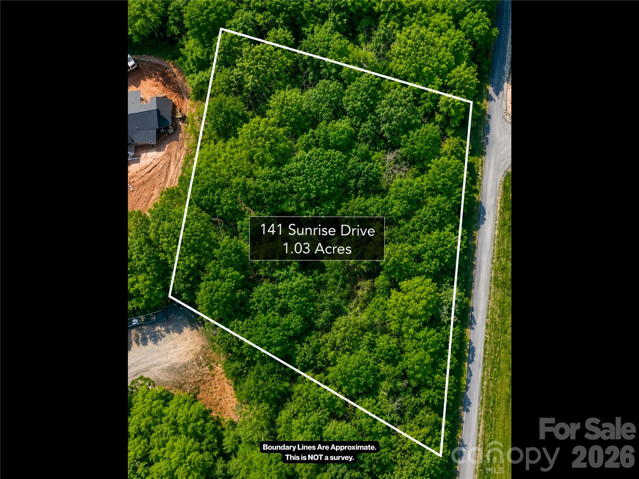 Affordable mountain homesite in a nice, established Mars Hill neighborhood with mountain views! Located in Sunrise Estates, Lot #14 offers 1.03 wooded acres with exquisite mountain views, paved road access, and the peaceful setting buyers want in Western North Carolina.

With a low 1,400 sq ft minimum build requirement, this lot provides a more practical and affordable path to building a new home without the pressure to overbuild. Whether you are dreaming of a full-time residence, a mountain retreat, or a future investment property, this homesite offers flexibility in a desirable Madison County location.

The setting feels quiet and tucked away, yet the convenience is hard to beat. You are just minutes from downtown Mars Hill, Mars Hill University, shops, restaurants, groceries, and I-26. Weaverville is approximately 15 minutes away, downtown Asheville is approximately 25 minutes away, and Johnson City is approximately 45 minutes away.

The property is wooded and sloped, offering natural privacy and the potential for a home design that captures the surrounding mountain scenery. Buyers should plan for a private well and septic system. Electricity is connected in the area, and French Broad fiber is available, making this an excellent option for buyers who work from home, need reliable internet, or simply want modern convenience in a mountain setting.

Interested in building but not sure where to start? Contact the Listing Agent to discuss the possibility of a land/home package on this lot with the builder/developer.

If you have been searching for affordable land for sale in Mars Hill, NC with mountain views, neighborhood appeal, and convenient access to Asheville, Weaverville, Mars Hill University, and Johnson City, this lot is worth a closer look.

Come see the view, walk the lot, and imagine what you could build in Sunrise Estates.