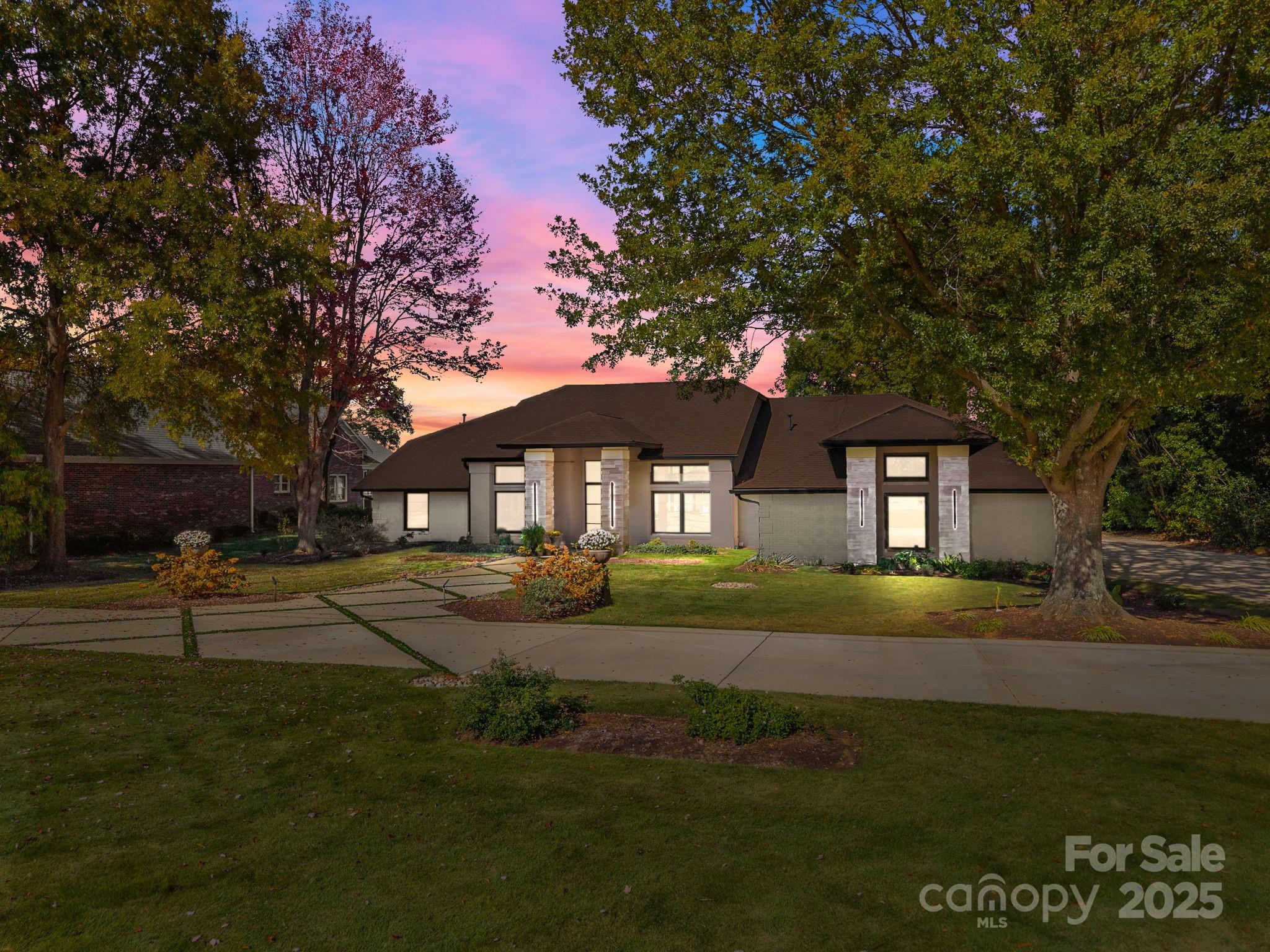 Welcome to 21400 Bethel Church where architectural elegance meets lakeside luxury. This one-of-a-kind four-bedroom custom-built ranch home, inspired by the timeless principles of Frank Lloyd Wright, showcases clean lines, soaring ceilings, and abundant natural light throughout. Designed for both comfort and entertaining, the open-concept layout centers around a private outdoor oasis featuring a sparkling pool and hot tub, wet bar, and panoramic lake views from nearly every room. Situated on a flat, meticulously landscaped one-acre lot—one of the most coveted parcels on Lake Norman—this property offers uninterrupted main channel vistas from its private cove location at the end of the Bethel Church Road peninsula. Enjoy deep water access from your private dock with boat and jet ski lifts, ideal for weekend adventures or peaceful sunset cruises. The spacious, accessible floor plan includes extra-wide hallways and doorways, with a primary suite that opens directly to the outdoor entertainment area for seamless indoor-outdoor living. Additional highlights include an expansive circular driveway, three-car garage, established lakeside garden with a built-in firepit, and a quiet, well-established neighborhood offering privacy and tranquility. A rare blend of architectural sophistication, functional design, and premier lakefront living—experience the lifestyle that awaits at 21400 Bethel Church.