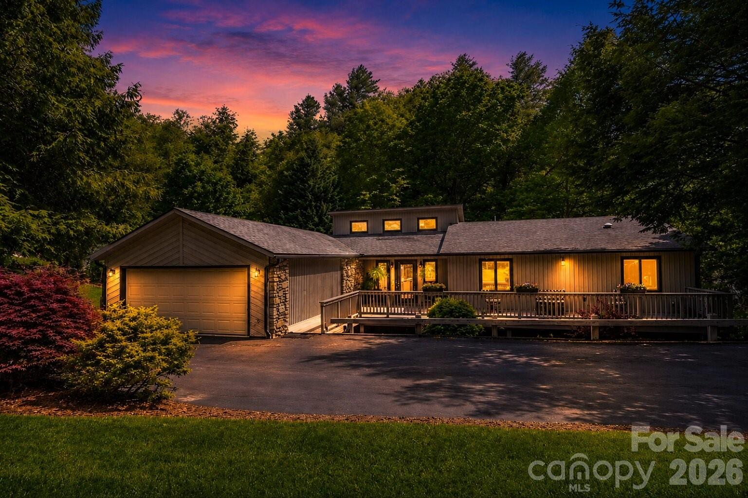 Tucked into the wooded hills of South Asheville, this 4-bed, 4-bath contemporary ranch is where everyday living feels like a retreat. Soaring 15-ft vaulted ceilings and a dramatic stone fireplace anchor the grand living room, while multiple decks invite you to slow down and take in the trees. The updated kitchen—granite counters, oversized island, walk-in pantry with custom built-ins—is built for the way people actually live. The main level flows effortlessly: primary suite with two walk-in closets, guest bedroom, laundry, and a screened-in porch made for morning coffee. Downstairs, a fully equipped second kitchen, two bedrooms, family room with fireplace, and a jumbo flex room make multi-generational living or long-term guests genuinely easy. Minutes from the Blue Ridge Parkway, Biltmore Park, and downtown. Sellers include a home warranty.