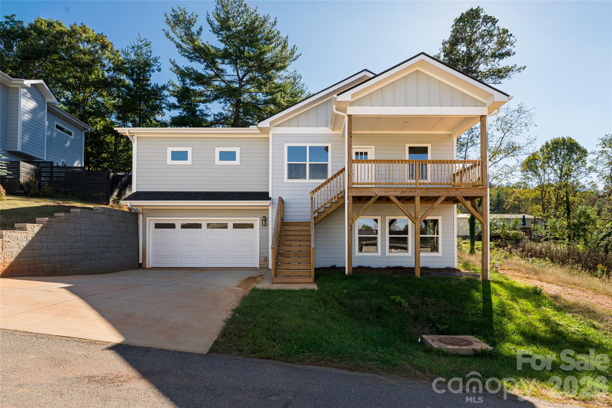 Experience modern mountain living at 65 Greenwood Fields Drive in Asheville, North Carolina. Nestled within the sought-after Greenwood Fields community, this brand-new 2025 construction combines contemporary craftsmanship with timeless style. Ideally located just north of downtown Asheville and conveniently positioned between Asheville and Weaverville, residents enjoy the perfect balance of accessibility and tranquility.

This thoughtfully designed 3-bedroom, 2-bath home offers approximately 1,523 square feet of finished living space, plus an additional +/-750 square feet of unfinished basement space already plumbed for a full bathroom, providing exceptional potential for future expansion, guest quarters, or income-producing rental space. With both interior and exterior access, the lower level is ideally suited for a separate living area.

The main level showcases rich hardwood flooring, a spacious great room anchored by a gas fireplace, and abundant natural light throughout. The gourmet kitchen features granite countertops, stainless steel appliances, and ample cabinetry; perfect for both everyday living and entertaining.

The split-bedroom floor plan provides privacy for the primary suite, complete with a walk-in closet and a well-appointed bath featuring dual vanities and a glass-enclosed shower. A separate laundry room adds everyday convenience. Enjoy outdoor living from the covered front porch or rear deck overlooking the surrounding landscape.

Constructed with durable hardboard siding and quality finishes throughout, this home offers low-maintenance, modern living. A two-car garage completes the property.

Additional opportunity: Two adjacent residential building lots are also available for purchase—see MLS #4365040 for details—offering expanded possibilities for investment, multi-home development, or added privacy.

Greenwood Fields is a thoughtfully planned community just minutes from shopping, dining, and outdoor recreation, delivering the best of mountain living with close proximity to all that Asheville has to offer.

Discover the perfect blend of quality, flexibility, and location at 65 Greenwood Fields Drive—your brand-new Asheville home awaits.