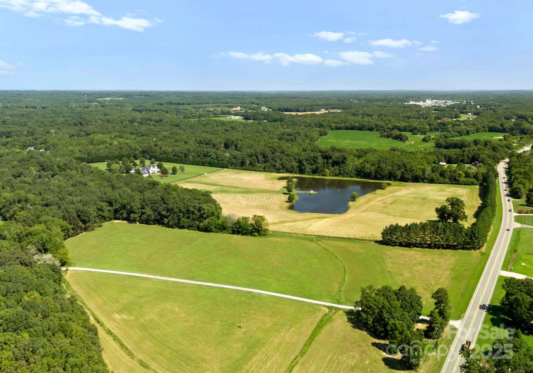 71+/- ac of farm land 50/50 cleared fenced pasture and wooded land.  Rolling Hills and bordered by creek.  Property has several buildings, hay barn and work sheds.