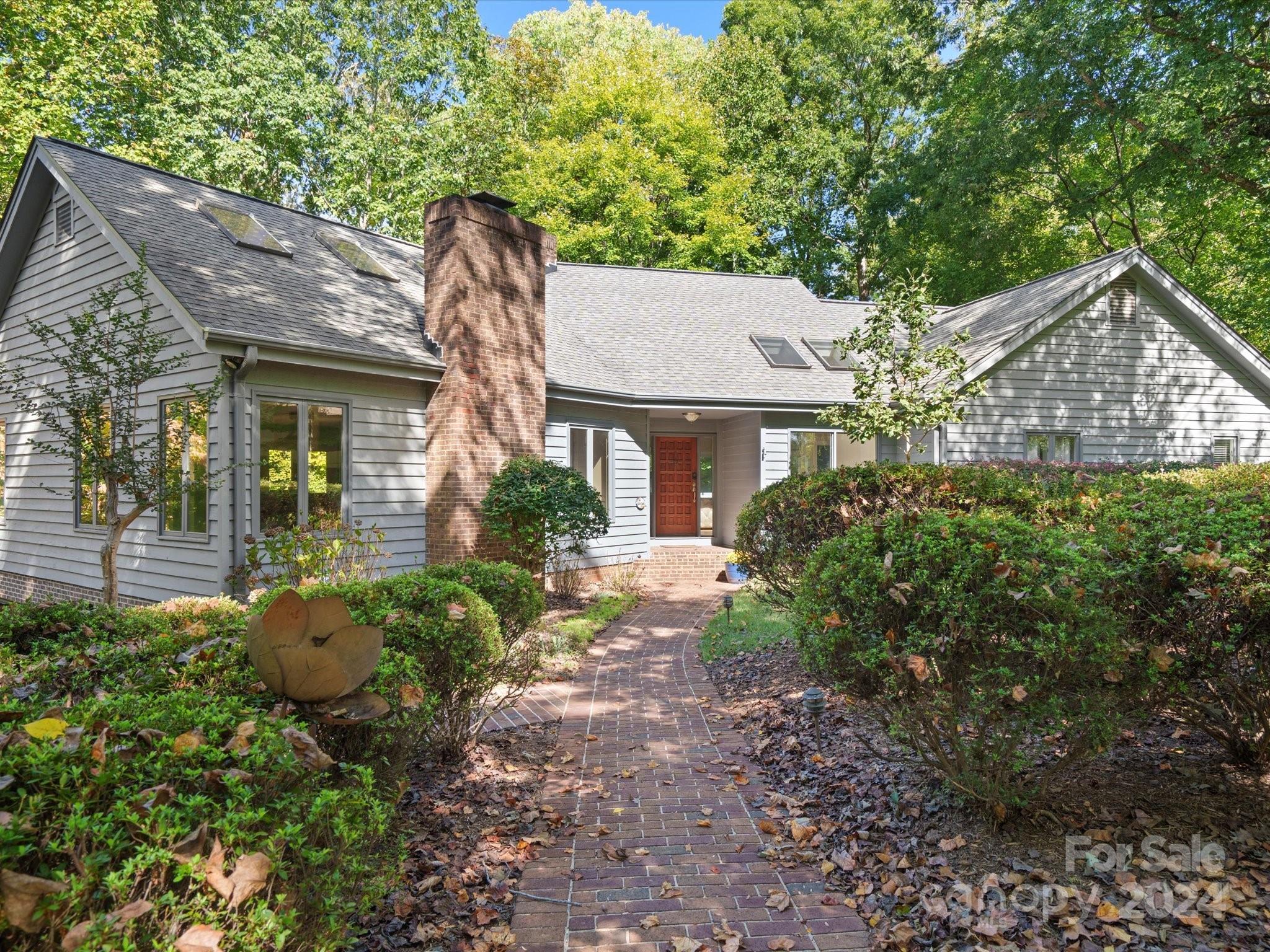 A serene ranch home in the gated River Hills community of Lake Wylie, where luxurious architecture meets natural tranquility. Enter to soaring ceilings and floor-to-ceiling windows framing breathtaking views of the wooded backyard and seasonal water vistas.
The elegant open floor plan features a modern kitchen with a spacious island, cooktop, and wine fridge—ideal for entertaining. High-end finishes like bamboo flooring, granite accents, and three cozy fireplaces enhance the home’s charm.
Enjoy two primary retreats for privacy, a craft room opening to the deck, and expansive upper and lower decks perfect for outdoor living. Recent updates include a new driveway, garage doors, gutters, and windows, ensuring a well-maintained home.
The community offers a beach, paddleboard launch, and lake access, making it a haven for outdoor enthusiasts. With low SC taxes and top-rated schools, this home is perfect for lake lovers seeking luxury and serenity. Schedule your showing today!