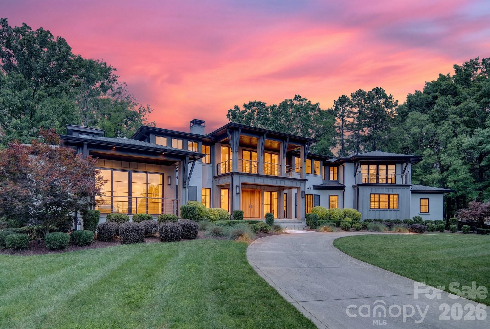 Experience the rare opportunity to enjoy both breathtaking Lake Norman views and premier golf course living in The Peninsula. Perfectly situated along the 18th hole and complemented by a deeded boat slip, this exceptional residence offers an unparalleled combination of beautiful water views and championship golf course frontage.
Designed with both elegance and functionality in mind, the home features 4 spacious bedrooms, 4 full bathrooms, and 2 half bathrooms. The chef's kitchen serves as the heart of the home, showcasing marble countertops, Ralph Lauren light fixtures, and a sunlit breakfast area overlooking the fairway. The main level is highlighted by a spectacular living room, where a dramatic concrete fireplace and an expansive wall of windows create a light-filled gathering space. The luxurious primary suite boasts expansive views of Lake Norman while offering a private retreat complete with a wet bar, oversized walk-in closet, and spa-inspired bath. Upstairs, dual staircases lead to a generous family room, three additional bedrooms with en-suite baths, and a versatile bonus room ideal for recreation, fitness, or media use. Fresh interior paint, hardwood floors, custom PowerView shades, and integrated Savant smart-home technology, blend sophistication with modern convenience.  Step outside to your own private resort-style oasis featuring a saltwater infinity-edge pool, spa, and expansive lanai. Entertaining is effortless with AquaLink pool automation, surround sound, an outdoor kitchen, and a dedicated pool bath. This extraordinary property captures the essence of luxury Lake Norman living—offering panoramic water views, spectacular golf course scenery, and an unmatched lifestyle in one of the area's most sought-after communities.