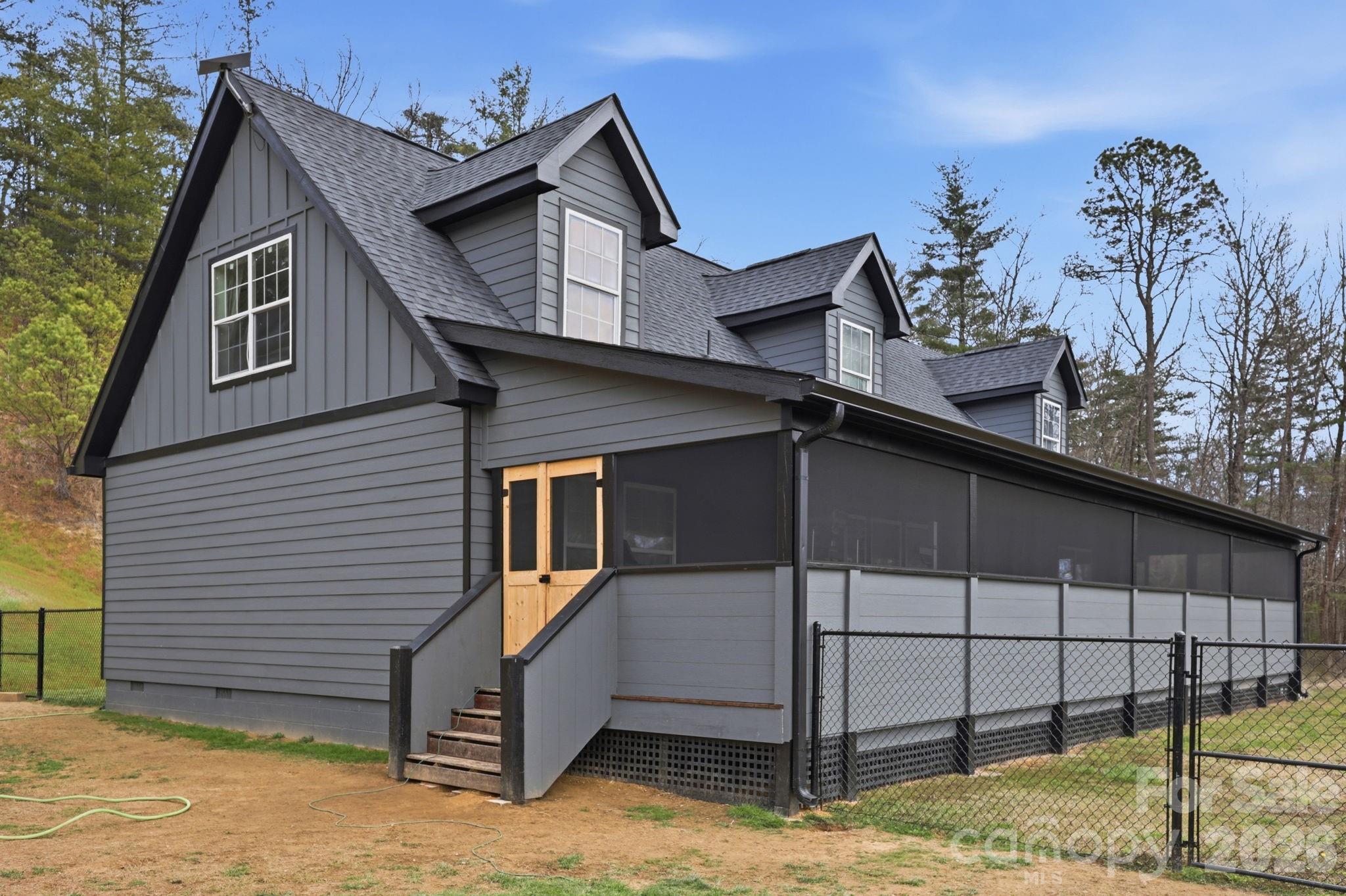 Perfectly positioned to capture the beauty of the Blue Ridge Mountains, 67 Nimitz Drive combines peaceful seclusion with everyday convenience—located just minutes from Pisgah National Forest and the vibrant shops, dining, and culture of Brevard’s downtown. Set on approximately ±2.42 unrestricted acres, this property invites you to enjoy true mountain living without limitations. Wake up to long-range mountain views and end each day with truly exceptional sunsets that paint the sky in unforgettable color. The expansive, fully fenced yard provides both security and flexibility—perfect for pets, gardening, or simply enjoying the outdoors. The home’s exterior has been extensively updated, showcasing thoughtful improvements that enhance both style and durability. One of the standout features is the full-length screened-in porch—an ideal space for relaxing, entertaining, or soaking in the peaceful surroundings year-round without the nuisance of insects. Inside, you will find new flooring, paint, and finishes that make the home feel brand new. With warm, neutral gray tones, this home has the perfect blend of soft color and materials that you desire. Whether you’re looking for a full-time residence, a mountain retreat, or an investment opportunity, this property delivers the space, freedom, and views that are increasingly hard to find—all while being conveniently close to world-class hiking, biking, waterfalls, and everything downtown Brevard has to offer.