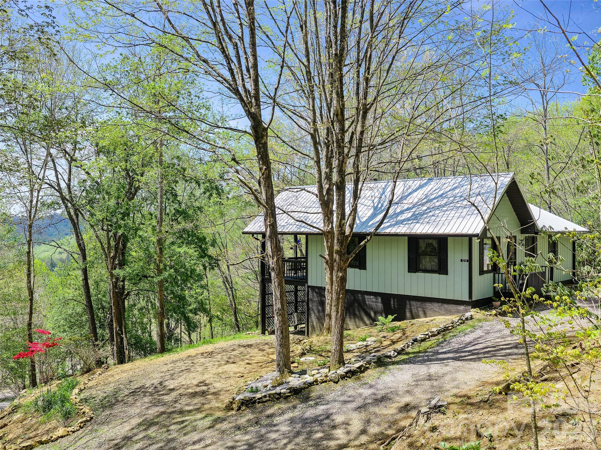 Escape to the mountains with this charming home in the desirable Glen Ayre community! Featuring 2 bedrooms 3 bathrooms and bonus room downstairs, this cozy retreat sits at a high elevation, offering beautiful mountain views and a peaceful setting. The classic A-frame design brings warmth and character, complemented by a woodstove fireplace—perfect for cozy nights after a day of exploring. The inviting layout makes it ideal for both full-time living or a relaxing mountain getaway. Step outside onto the covered porch and take in the fresh mountain air and scenic surroundings—perfect for morning coffee or evening sunsets. Conveniently located near the renowned Appalachian Trail, this home is a dream for outdoor enthusiasts, with hiking and adventure just minutes away. Whether you’re searching for a vacation retreat or a year-round home, this “super cute” mountain property offers charm, comfort, and an unbeatable location.