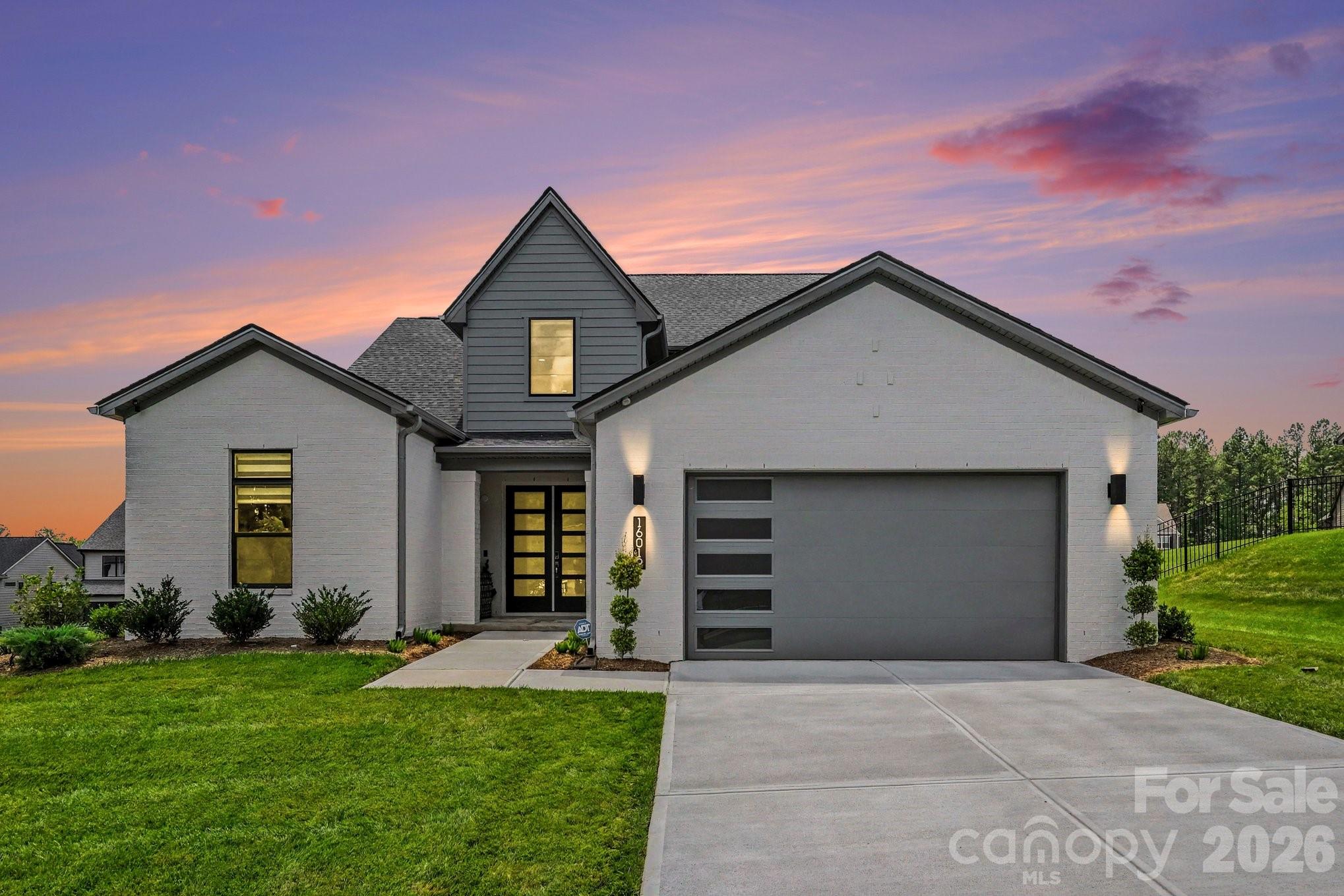 Welcome to one of the most extensively upgraded homes in Amara Chase. This nearly new Shea Homes Willow floor plan offers 3,537 square feet of luxury living with 4 bedrooms and 4 full bathrooms, enhanced by extensive builder upgrades and owner-added custom improvements, creating a truly turnkey residence that exceeds new construction. Designed for seamless indoor-outdoor living, the heart of the home features a dramatic 12-foot rolling glass wall that opens the great room to a covered outdoor living room with a gas fireplace, creating an exceptional entertaining experience rarely found in the area. The great room is anchored by a contemporary linear gas fireplace, providing a stunning focal point for everyday living and entertaining. A second-story covered deck expands the outdoor living space and is prewired for future audio and entertainment. Inside, the open-concept floor plan showcases a designer staircase with exposed oak treads and modern horizontal railing, luxury flooring throughout, crown molding throughout the home, custom wood casing around windows and doors, and thoughtfully curated finishes. The chef’s kitchen is equipped with a premium KitchenAid commercial-style appliance package, custom furniture-style wood range hood, expanded cabinetry, quartz countertops, designer porcelain backsplash, under-cabinet lighting, and an oversized island designed for gathering and entertaining.
The main-level primary suite serves as a private retreat featuring an elegant tray ceiling, a spacious bay window sitting area filled with natural light, and a spa-inspired bath with a three-head shower system, floor-to-ceiling designer tile, porcelain flooring, dual vanities, and a spacious walk-in closet with upgraded porcelain flooring and prewiring for a future designer chandelier. Designer tile extends to the ceiling in all bathrooms, creating a custom-home aesthetic throughout, the technology and convenience are seamlessly integrated with Lutron smart lighting, motorized smart shades, smart thermostats, smart irrigation, smart entry lock, integrated Sonos ceiling speakers, in-wall iPort controls, professionally wired Samsung Frame TV installation, CAT-6 wiring, Eero whole-home mesh WiFi system, prewiring for landscape and outdoor deck speakers, and a comprehensive Ring security camera system providing 360-degree exterior coverage. Additional flexible living spaces include a dedicated home office/gym, private cinema room with projector outlet, expansive bonus room, mudroom, and an oversized garage featuring a utility sink and a 4-foot garage extension for added storage and functionality. Outside, the professionally landscaped grounds are enhanced by a black aluminum fence, large pool-sized homesite, and motorized outdoor privacy screens, providing comfort, privacy, and year-round enjoyment of the outdoor living spaces. Offering the benefits of new construction without the wait, this highly customized smart home remains under the Shea Homes builder warranty, providing added peace of mind and confidence for its next owner. Better than new construction—fully upgraded, professionally enhanced, thoughtfully customized, and still under builder warranty. This is one of the larger lots with plenty of room for future pool and outdoor entertaining. Enhanced for privacy with privacy screen and usable outdoor space makes it very unique home.
