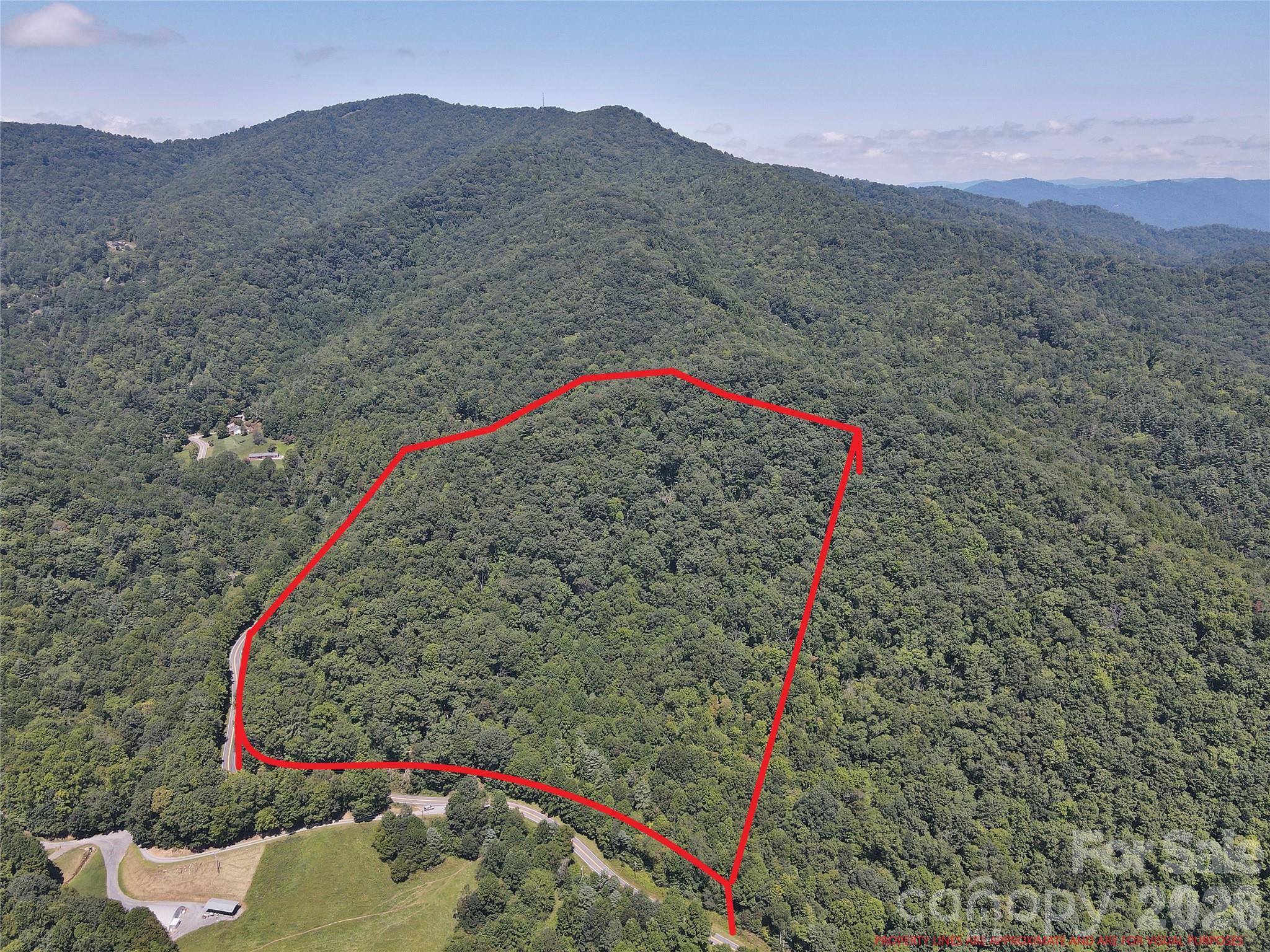 Updated pricing under taxable value!! Beautiful 20+ acre mountain property located along paved Cove Creek Road in Waynesville, NC. The land offers excellent road frontage and a gravel driveway leading to a cleared homesite, making it easy to access and explore. Multiple potential build sites are located throughout the property. Mature hardwood forest and rolling mountain terrain provide the peaceful setting buyers seek in Western North Carolina. Conveniently located near Waynesville, Maggie Valley, the Blue Ridge Parkway, and Great Smoky Mountains, offering easy access to hiking, outdoor recreation, dining, and shopping. The property is currently enrolled in the Forest Management Program for reduced property taxes but can be removed if desired. Ideal for a private mountain home, cabin retreat, vacation property, or land investment in the Smoky Mountains. Soil test passed and electric at road.
