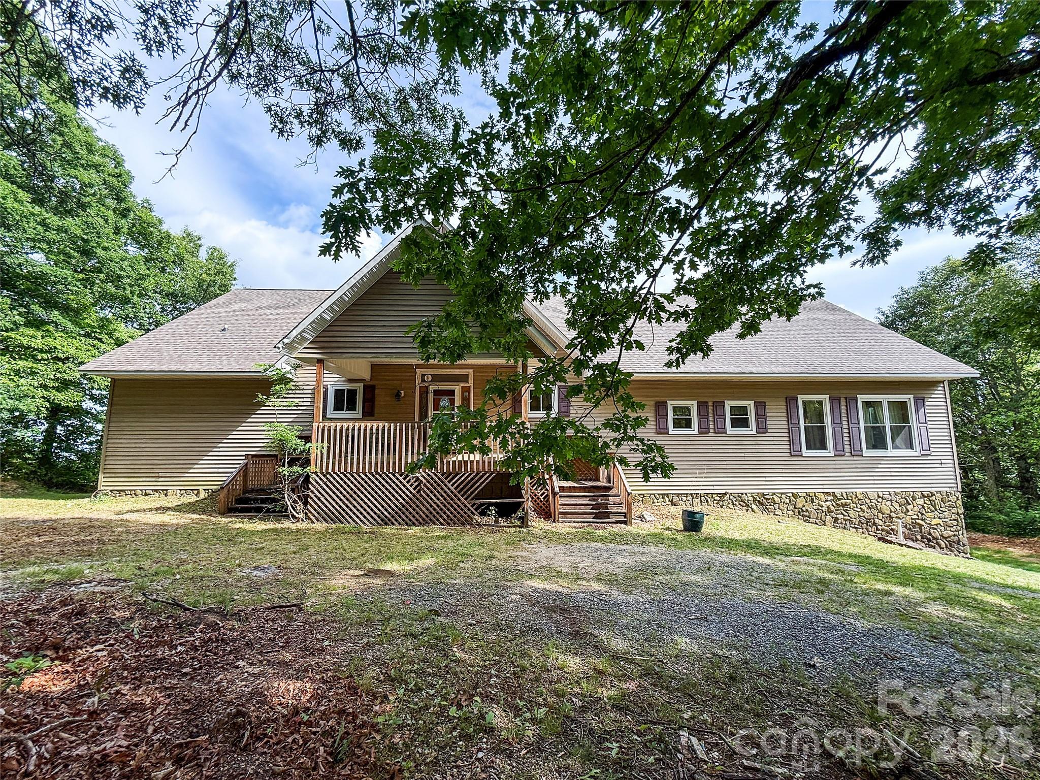 Rare opportunity to own a stunning mountain retreat perched high in the Blue Ridge foothills of Columbus, NC, offered exclusively via online auction ending July 30, 2026. This remarkable 3-bedroom, 2-bath home spans 3,448 square feet of living space across two finished floors, crowned by soaring vaulted ceilings that frame sweeping, panoramic views you have to see to believe.
The moment you arrive, the setting commands your attention — an elevated ridgeline perch on 1.76 acres (two lots) delivers long-range mountain vistas from virtually every angle. Step inside the dramatic great room and be greeted by soaring vaulted ceilings with exposed tongue-and-groove wood, a floor-to-ceiling stone fireplace, and walls of glass that capture the mountain panorama.
The main level features an open-concept living and dining area designed for entertaining, a well-appointed kitchen, a spacious primary suite with private bath and walk-in closets, two additional bedrooms, and multiple sun rooms that extend your living space while keeping the views front and center. A huge vista deck gives you outdoor living space on a grand scale — perfect for morning coffee or evening sunsets over the Blue Ridge. Two separate sunrooms add to the flexible indoor/outdoor living spaces.
The 2nd floor adds a generous office/loft overlooking the main living area — ideal as a home office, studio, or bunk loft. Below, a massive partially finished basement with garage access and abundant storage provides tremendous potential for expansion, workshop space, or additional living area.
Whether you envision a full-time residence, vacation retreat, or short-term rental investment in the heart of Polk County's thriving mountain community, 386 Arrowhead Trail delivers the views, the space, and the rare auction opportunity you've been waiting for. Don't miss your chance — bid online now!