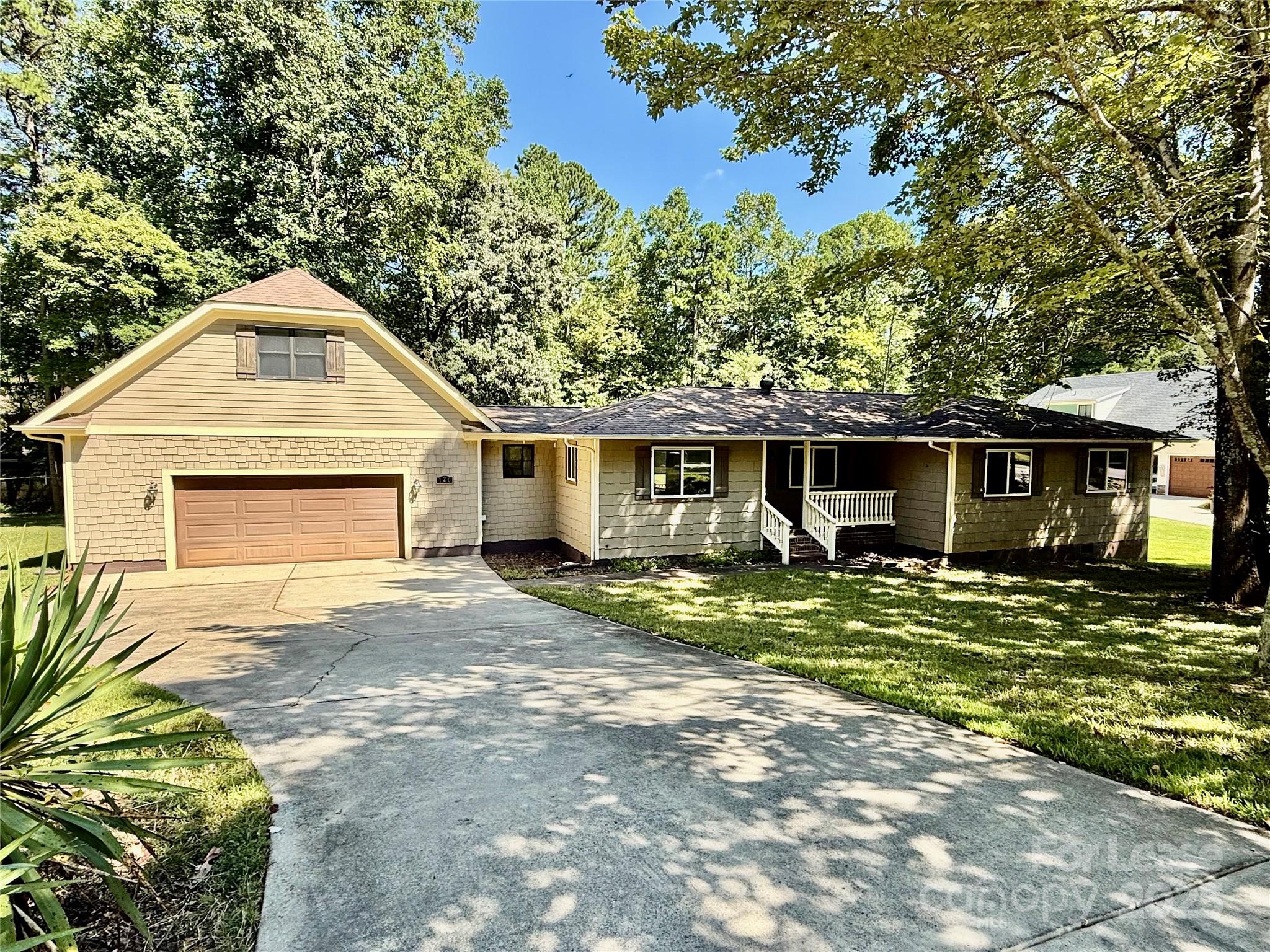 Are you looking for a peaceful and secluded place to live? Welcome to this charming one-story home situated on a 0.58-acre private lot! This freshly painted house includes a bright living room with multiple windows and an open dining area adjacent to the kitchen, which features updated white cabinets, granite countertops, a large island, and stainless-steel appliances. The primary bedroom offers a large closet and an updated en suite bathroom with dual sinks, granite counters, tile flooring, and a tub/shower with tile surround. Two additional bedrooms share an updated bathroom with similar finishes. Additionally, there is a spacious bonus room above the garage for various uses. The 760 sqf oversized garage provides space for vehicles and storage. The huge backyard is peaceful and private. It is perfect for you to entertain your guests or just enjoy your coffee on the sizable deck surrounded by the sounds of nature looking out onto established trees. A hot tub on the deck and solar panels installed to reduce utility costs certainly are the bonus for you. Located just minutes from Lake Norman, shopping, dining and entertainment.