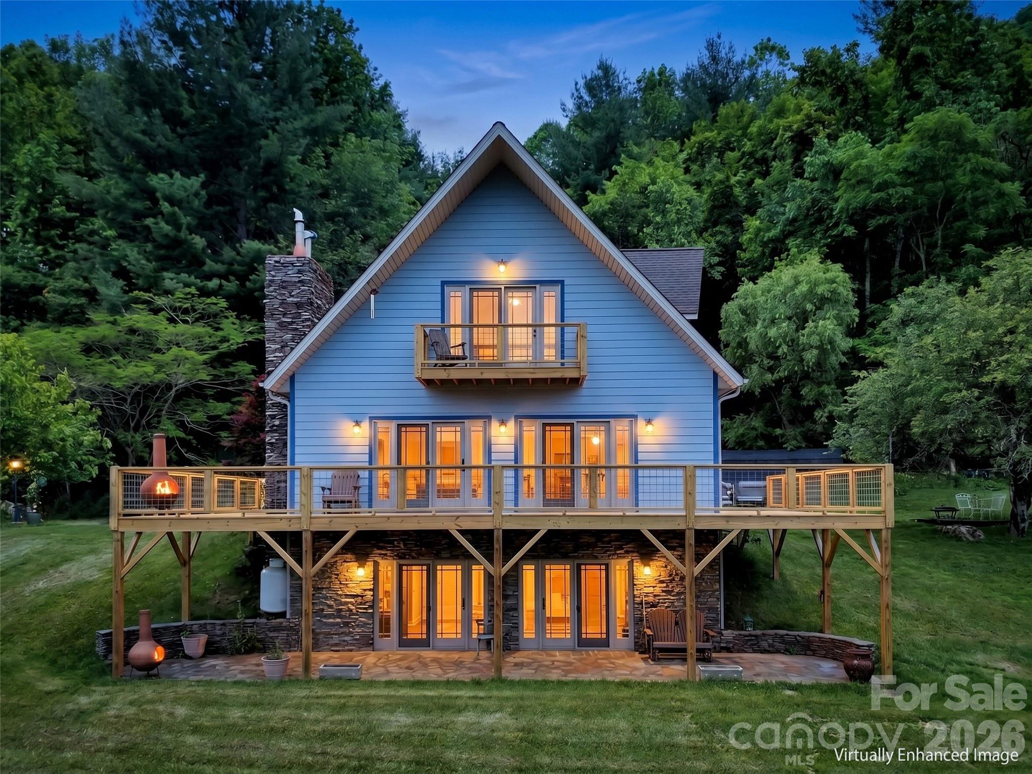 Escape to your own private oasis in the heart of Yancey County! Nestled on 20 acres of pristine land, this stunning property offers breathtaking views, a tranquil pond, and mature landscaping that enhances the beauty of its natural surroundings. This spacious home features 3 bedrooms, 3 bathrooms, and an open-concept layout designed for comfortable living. Large windows throughout the home frame picturesque mountain vistas, while the inviting outdoor spaces provide the perfect setting for relaxation and entertaining. Spend your evenings admiring the views from the newly rebuilt deck. For car enthusiasts or those needing ample storage, the detached 4-car garage is a standout feature, offering space for vehicles, recreational equipment, or a workshop. Whether you’re looking for a peaceful retreat, a place to explore nature, or simply a private sanctuary, this property is a rare find. Don’t miss your chance to own this slice of paradise! No drive-by's please. Seen by appointment only.