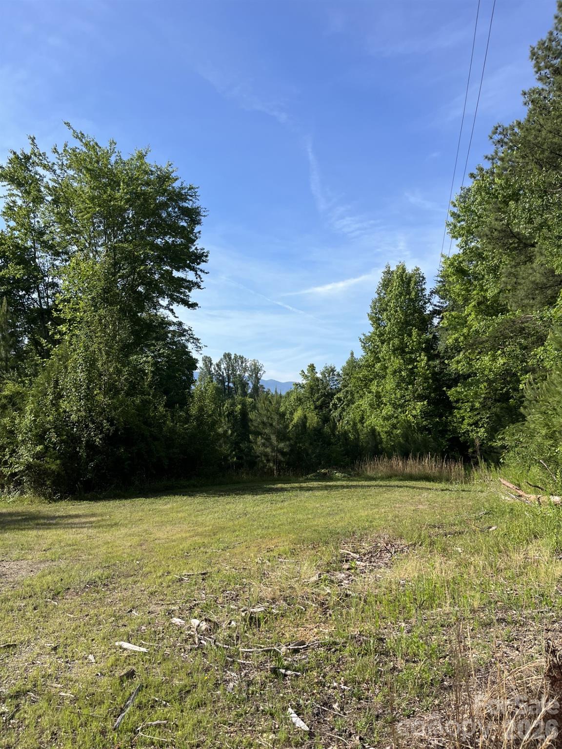 This property is priced to sell.  Because of the proximity to Interstate 40 and Exit 100, this could represent a valuable parcel for immediate use or a long term hold and gain.  This 18 acre tract has an abandoned house, built in 1916, and an abandoned mobile home on site.   The property slopes from front to back and of the 18 acres, approximately 7 acres in the rear or south end of property is in flood plain.  Property is adjacent to Aumovio, formerly Continental.  Old Hush Puppy Avenue is a frontage road for Interstate 40, Exit 100.  The interchange for Exit 100 is planned for replacement and reconfiguration at a yet to be determined time.  Public water is available through Brentwood Water Corporation or the City of Morganton.