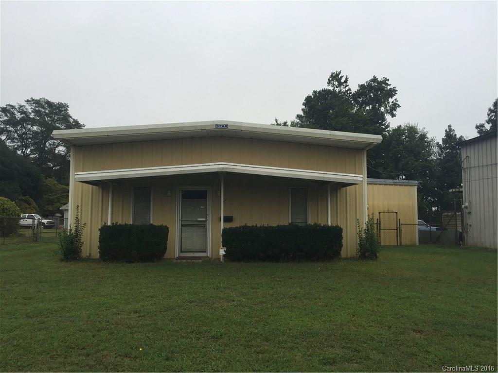 Limited Commercial District.  Spacious Building with tons of opportunities in growing Downtown Rock Hill.  Large office with private full bathroom and 1/2 bath in the large warehouse/garage area.  4 Ton Gas Pack can be included but is not installed/connected.