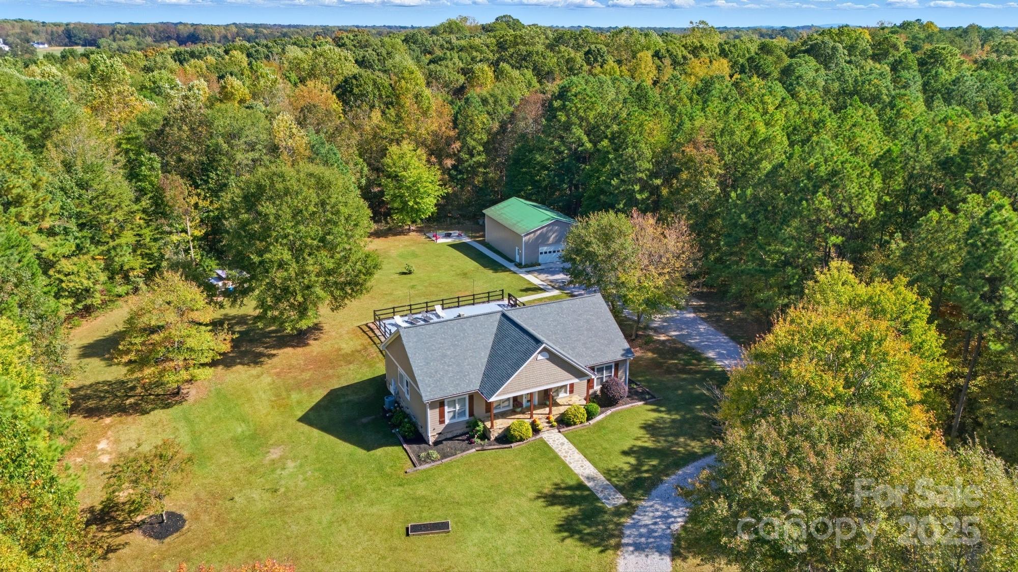 This beauty is back on the market with no fault to the sellers, and it’s your second chance to make it yours!
Nestled in the heart of York County’s scenic countryside, this stunning 10.4-acre estate offers the perfect blend of privacy, comfort, and versatility. Built in 2005, this single-story home features 4 spacious bedrooms, 2.5 bathrooms, and an inviting open-concept layout designed for both relaxation and entertaining.

Step inside to find a warm and welcoming interior with a cozy living room, large windows that flood the space with natural light, and a well-appointed kitchen with ample cabinetry and counter space. The primary suite boasts a generous layout with a private bath, while the additional bedrooms offer flexibility for guests, home office, or hobbies.

Outside, the property truly shines. Enjoy summer days by the in-ground pool, host gatherings on the expansive lawn, or explore the wooded acreage that surrounds the home. A detached garage/workshop provides 1,200 sq ft of space for vehicles, tools, or creative projects. With AGC zoning, the land offers endless possibilities—from gardening and recreation to small-scale farming or equestrian use. 
(Please check with Zoning for any restrictions)

Located just minutes from Clover’s charming downtown and top-rated schools this property offers the tranquility of rural living with convenient access to shopping, dining, and Lake Wylie.

Whether you're seeking a peaceful homestead, a hobby farm, or a private family compound, 1240 Beamguard Rd is a rare opportunity to own a slice of Carolina paradise.