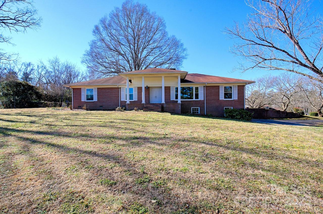 Welcome to this enchanting brick ranch, perfectly situated on a sprawling 2.18-acre corner lot overlooking the Spring Lake Golf Course. This home features 3-bedroom, 3.5-bath home offers comfort and style throughout. The beautifully renovated kitchen flows into a bright, open great room with a cozy wood-burning fireplace, ideal for entertaining. Natural light floods the home, with serene views from the glass-enclosed sunporch. The expansive basement has tremendous potential, featuring a full bath, utility sink, wood-burning fireplace, and additional garage access—perfect for a workshop, storage, or future living space. Outside, enjoy the stone patio or relax on the rocking chair front porch. Additional features include a 2-car attached carport and a detached garage with electric and water, offering endless possibilities. With no HOA and a rare combination of charm, privacy, and functionality, this home is truly a hidden gem. Don’t miss your chance to make it your forever home!