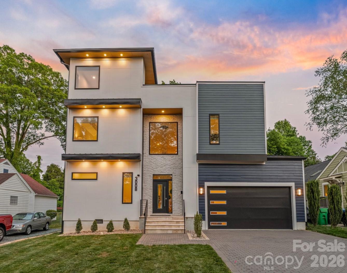 Welcome to 3008 Holt Street — where modern design meets one of Charlotte's most sought after neighborhoods. 
Completed in 2023, this striking 4 bedroom, 5 bath residence spans over 4,000 square feet of refined, light-filled living space. This home delivers effortless luxury, timeless sophistication, and an elevated lifestyle. 
Step inside the dramatic two-story foyer and you’re immediately embraced by an open-concept living area flooded with natural light. Soaring ceilings, clean architectural lines, and seamless flow create the perfect stage for both intimate evenings and large-scale entertaining. The heart of the home is the expansive main living space, where a sleek chef-inspired kitchen with premium quartz countertops, gas range, and abundant custom storage flows seamlessly into the dining and living areas framed by walls of windows.
Just beyond, a covered porch overlooks the fully enclosed, private flat backyard, creating the perfect setting for effortless indoor-outdoor living.
Upstairs, the second level offers four generous bedrooms and three full bathrooms. The primary suite is a true retreat, boasting a lavish walk-in closet, spa-like oversized shower, and dual vanities crafted for daily indulgence.
The crowning jewel awaits on the third floor: a spectacular, versatile entertainment level that opens onto an expansive 1600sq ft private rooftop terrace. Enjoy the breathtaking sunsets and nighttime city views as your backdrop - this is the ultimate flex space destined for unforgettable gatherings, or quiet evenings under the skyline. 
Perfectly positioned just minutes from NoDa’s vibrant arts scene, Plaza Midwood’s eclectic charm, and Uptown’s energy, this home is more than a residence—it’s a rare opportunity to own a statement property at the center of Charlotte’s energy, growth, and lifestyle.