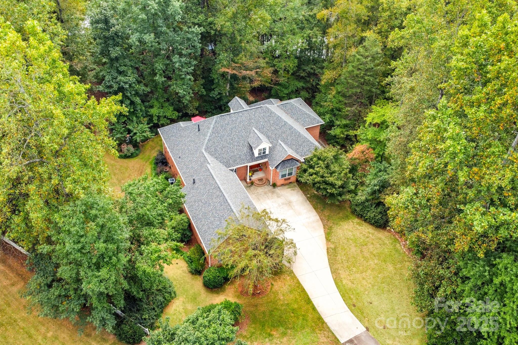 Welcome to your private retreat at 316 Brigadier Dr in charming Clover, South Carolina—nestled on 2.3 acres and tucked into a quiet cul-de-sac, this home offers the perfect blend of space, comfort and natural beauty. With four bedrooms, an open floorplan and a layout that flows beautifully, this is one you’ll want to see.

Step inside and you’ll be greeted by a bright, crisp white kitchen with stainless steel appliances and a stone backsplash that gives it real visual impact. The kitchen opens to a living area anchored by a large stone fireplace—ideal for cozy evenings yet still open enough for everyday life. On the main level you’ll find the primary suite complete with an ensuite bathroom featuring dual vanities and a walk-in closet. Also on the main level are three additional bedrooms—yes, all on one floor—with easy access and plenty of flexibility.

Head upstairs and you’ll discover a huge bonus room that can morph to suit your lifestyle: media room, playroom, home office — you name it. Plus there’s another bedroom and a full bath upstairs for guests or growing families.

Now, the lot—that’s the showstopper. 2.3 lush acres backing to a private pond set the tone for tranquility. Imagine sipping your morning coffee on the deck, looking over the water, watching the sun splash across your own backyard oasis. The setting is serene — and the space is generous. Plus, being situated in the respected Clover School District adds a big check in the “future” column for families.

Bonus features? HVAC systems were replaced last year, so you’re starting fresh with that major infrastructure. Plus the fridge in the garage, washer and dryer that come with the home all convey!

If you’re looking for a home that gives you space—both inside and out—peace and privacy in a great school zone, and style that’s ready to go, this one deserves your attention. Let’s set up a walkthrough and let this home speak for itself.