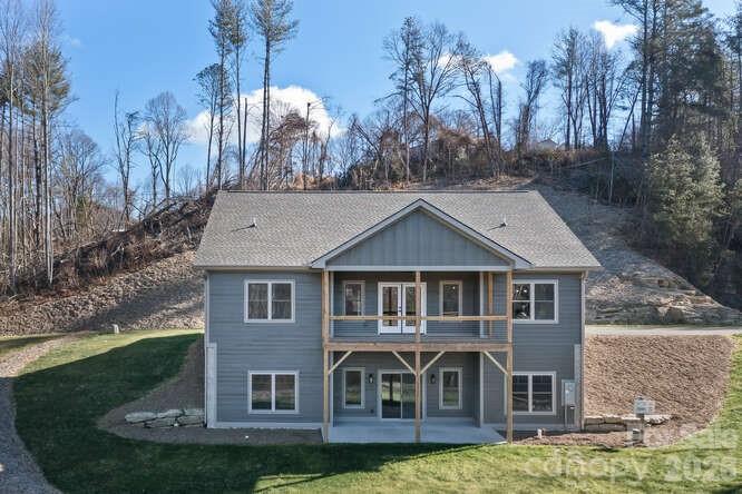 Discover exceptional new construction on Hutch Mountain in Fletcher, NC, tucked within a desirable gated community offering privacy, security, and a peaceful mountain setting. This home is situated on a truly unique private lot at the end of a cul-de-sac, not shared with any other homes, creating a rare sense of seclusion. Enjoy beautiful long-range views from the covered back porch, perfect for relaxing or entertaining while taking in the natural surroundings. The main level offers 1,759 square feet of thoughtfully designed living space with two bedrooms and an open, functional layout. The finished basement adds an additional 1,502 square feet, featuring a versatile bonus room ideal for a home office, media room, or guest space, along with a deep unfinished storage area providing ample room for equipment, hobbies, or future expansion and a third bedroom. A two-car garage adds everyday convenience. This property combines modern construction, generous square footage, and a premium mountain location just minutes from Fletcher amenities.