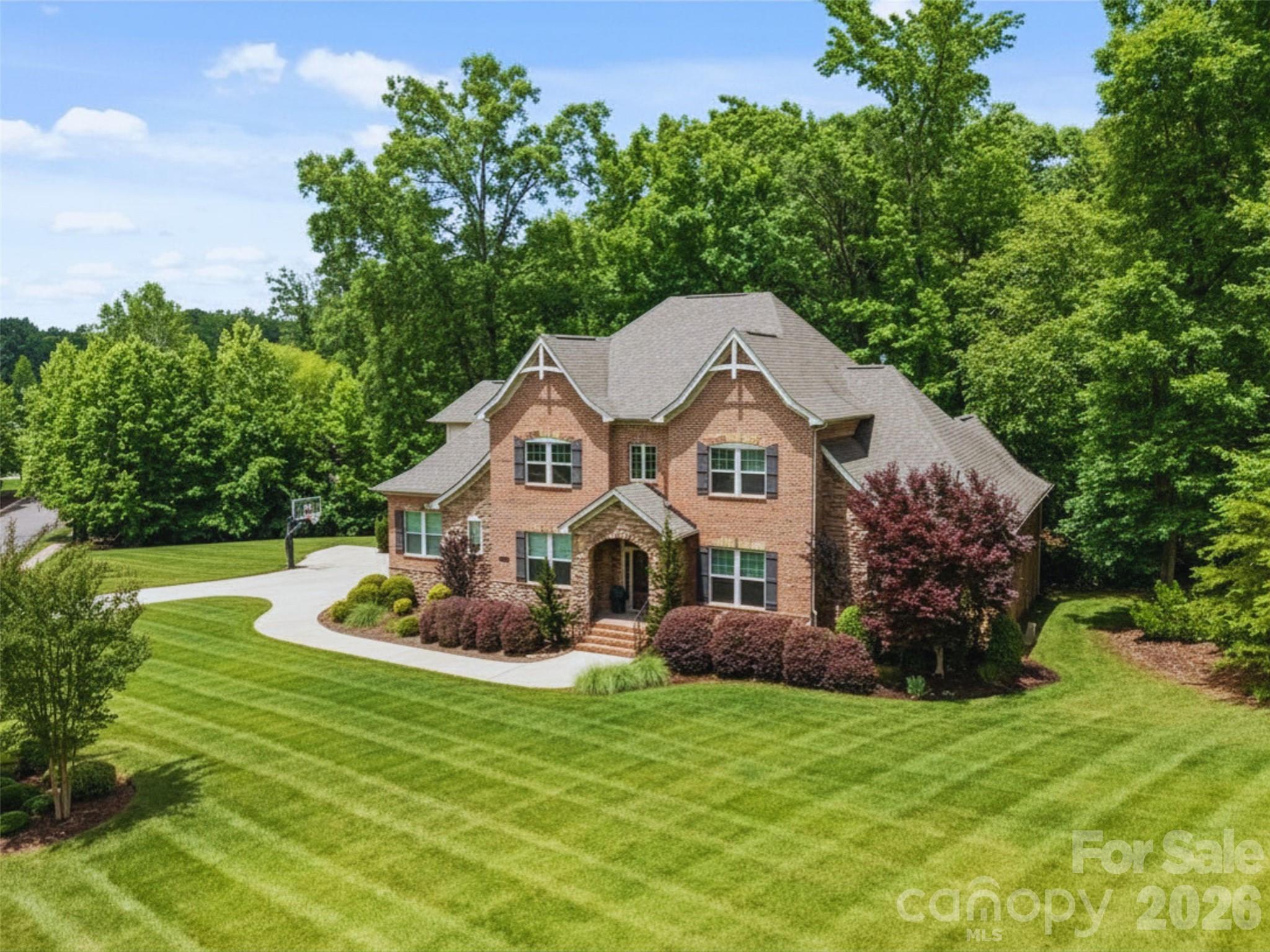 Meticulously maintained and privately nestled on an extraordinary 1.42-acre wooded homesite, this stunning home with a 3-car side-load garage offers the perfect blend of elegance, comfort, privacy, and lifestyle. Located within the exclusive gated community of Farrington, this rare property combines an estate-like setting with everyday convenience and access to Ballantyne + S.C. top-rated schools.

Rich hardwood floors set the tone for the home’s timeless design, while the open floorplan flows effortlessly from room to room, ideal for both everyday living and entertaining. The spacious kitchen features abundant storage, a walk-in pantry, custom cabinetry, gas range, stainless steel appliances, and a generous center island overlooking the main living area. Designed as the heart of the home, the space is ideal for gathering, meal prep, and everyday connection. The great room showcases beautiful architectural detail, custom builtins, and a cozy gas fireplace that creates a warm and inviting atmosphere.

The main-level primary suite is a true retreat, featuring vaulted ceilings, a luxurious en-suite bath, spacious walk-in closet, and direct access to the screened porch. Upstairs, the second level offers four spacious secondary bedrooms with en-suite or Jack-and-Jill baths, providing both comfort and privacy, along with a large bonus room complete with its own fireplace and endless flexibility for a media room, playroom, or additional living space.

Surrounded by mature trees and backing to woods, this breathtaking oversized homesite offers a rare sense of privacy just minutes from Ballantyne. The expansive screened porch, accessible from both the primary suite and main living area, creates an ideal space to enjoy the setting year-round. Whether sipping morning coffee or relaxing at the end of the day, the outdoor living spaces provide a true retreat-like feel to the home. Located just over the South Carolina border, take advantage of top-rated schools and lower South Carolina taxes while maintaining convenient access to Charlotte. Offering luxury, space, and an exceptional setting within Farrington, this is a rare opportunity in one of the area’s most desirable gated communities. Pre-inspected for buyer confidence, with repairs and improvements already completed.