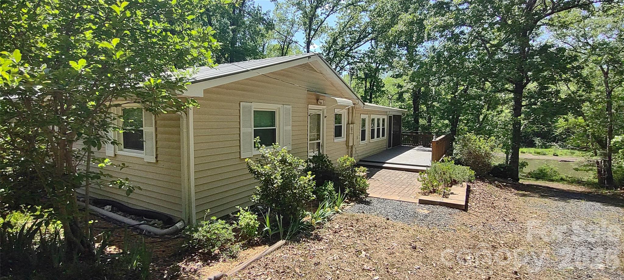Sportsman's paradise. Fish from your dock and hunt across the driveway in NC Game Lands. Waterfront on Lake Tillery. Secluded and north boundary is NC Game Lands. Cut though peninsula across from dock is wide enough for pontoon boat, takes you to main channel. This cuts down on boat traffic. House was completely updated in 2020 with new insulation, sheetrock, updated wiring, quartz counter tops in kitchen, recessed lighting with LEDs throughout, new cabinets, sinks, all new appliances, all new baths with clear showers, all new flooring, all new paint inside and out. New screened porch. Trex boat doc, trex decking, paver patio,  GFIs, gutter guards. 20 minutes from Albemarle. Very private.  Tree lined entrance.