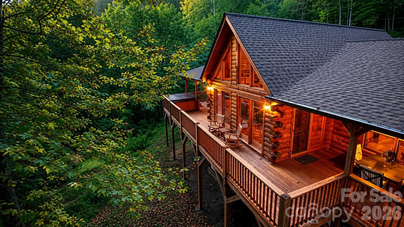 Experience mountain living at its finest in this stunning log home, featuring a stone gas-log fireplace and a spacious front deck—perfect for entertaining or soaking in the fresh mountain air. Sunlight floods the living spaces, accentuating breathtaking winter mountain views. Enjoy soaring cathedral ceilings and beautiful wood interiors throughout the main living area. The large master bedroom offers a walk-in closet and a comfortable bath. Step through the French doors onto the deck to discover a relaxing hot tub, ideal for unwinding after a day of adventure. The finished basement provides a game room with a pool table, a bonus room, extra sleeping space with a full bath, and a laundry area—giving you plenty of options for guests or family fun. A 22x15 garage/storage area meets all your toy or small car, workshop or storage needs, and a firepit in the side yard invites cozy evenings outdoors. Comes Furnished, ask for details. Conveniently located just 35 minutes from Asheville and 10 minutes from Sylva or Waynesville. CURRENTLY A VACATION RENTAL. 24 HOURS NOTICE TO SHOW.