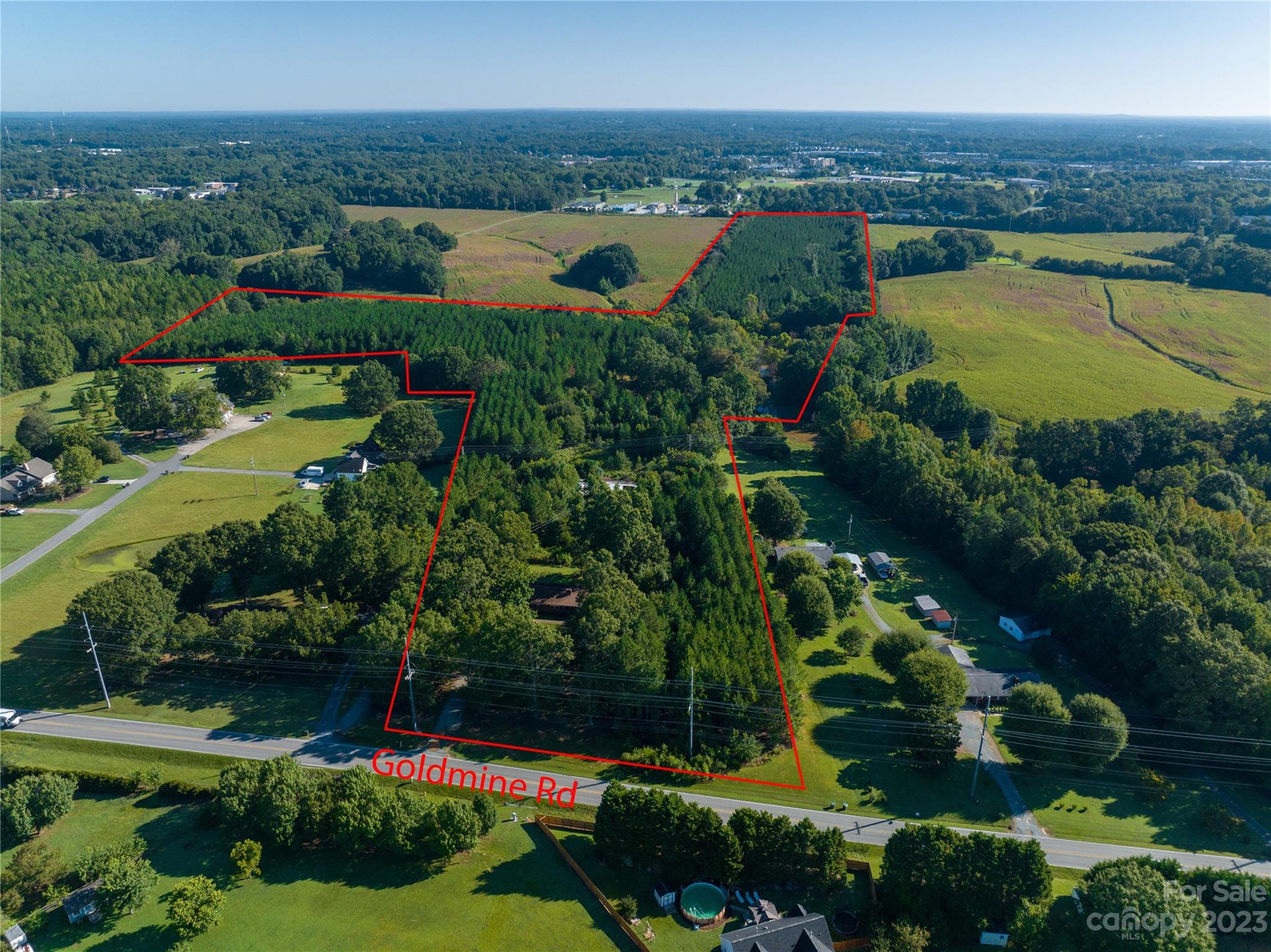 This conveniently located parcel with approx 29.22 acre is ideal to use for many acreage related purposes. Possible combination with adjoining acreage for sub-development or use the existing house for continued rental income or plan for use as owner occupied property when lease expires. Timbered and re-planted with pine trees approx 12 years ago. Flowing creek on property. Some floodplain/wetland. Bordered by Goldmine Rd. and CSX Railroad. Property may have existing buried oil tank near house. Monroe city water and sewer, electricity, natural gas and fiber optic cable are all available. Current zoning of RMD (Residential Medium Density) allows for 12000 sqft minimum lot sizes with at least 75' of road frontage. Listing agent David Kluth is minority shareholder of seller Goldmine Farms, Inc.