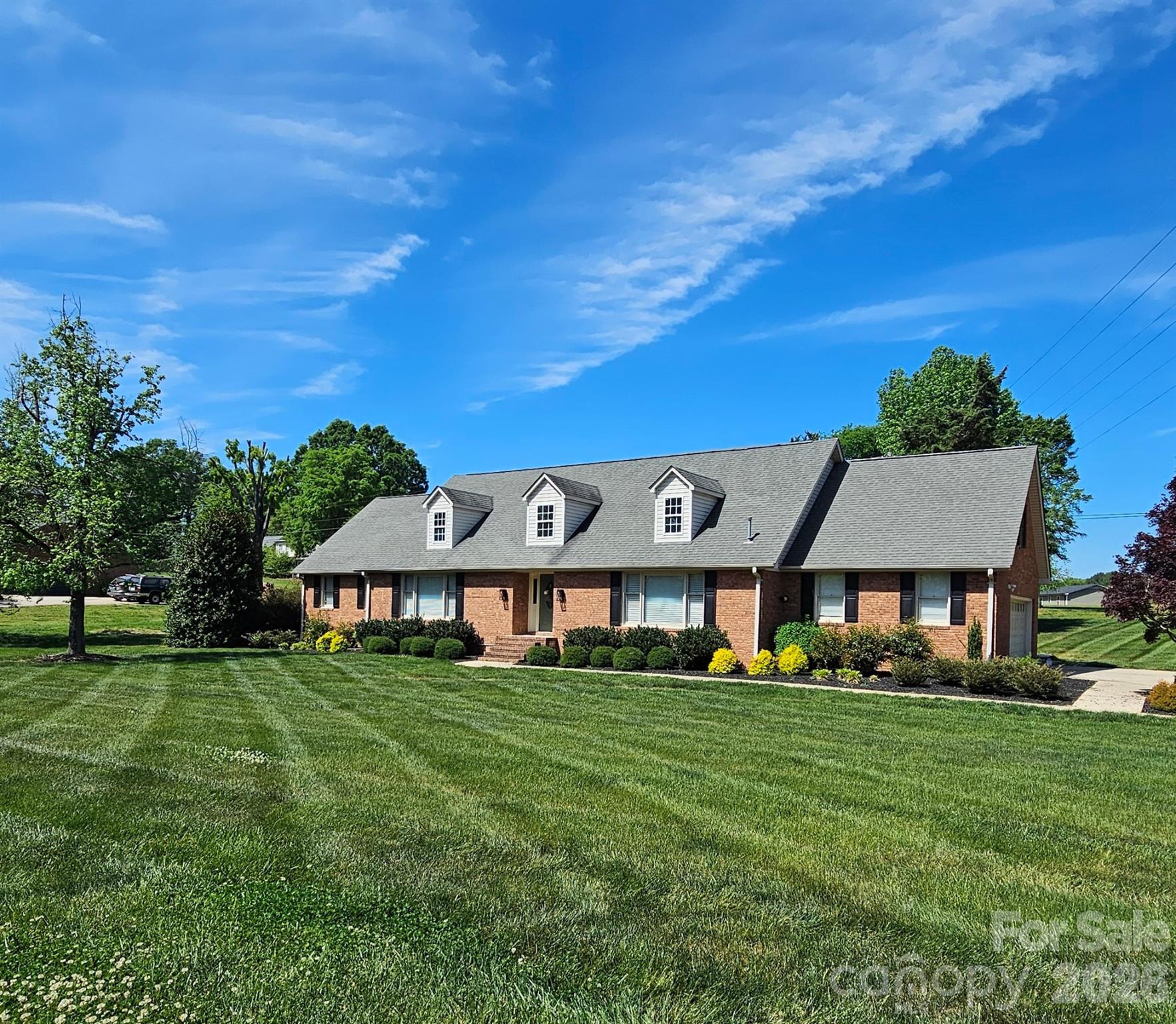 Once you enter into this stunning executive style home you will immediately notice the charming warm wood floors and spacious interior. Loads of character thru out! The living room is custom made for entertaining, black quartz counters, built in ice maker, wine cooler, bar sink and shelving, awesome use of space and it segways into  a wainscoted wall dining room.Then a fabulous den with rock fireplace and excellent built in bookshelves on either side of it. The kitchen is set up for those that love to cook and is a great place to gather with its oversize island and plenty of cabinets . Closets everywhere. The spacious owners suite is downstairs with plenty of privacy and enabling one level living. The upper level has 3 bedrooms and 2 full baths , perfect for guests or large family. Truly a bonus is a great flex space over the garage, ideal for media room , playroom , hobby room or mancave? What about a cave for the lady of the house ?!, no worries there is another fabulous flex space available for multiple uses. Spacious sideload garage with plenty of storage .Outside there is a nice yard with beautiful plantings and a deck off the kitchen , super for the grill and summer time entertaining. The home sincerely has something for everyone. Great looking street stunning yards and homes in this lovely established neighborhood. Come look you will love it !