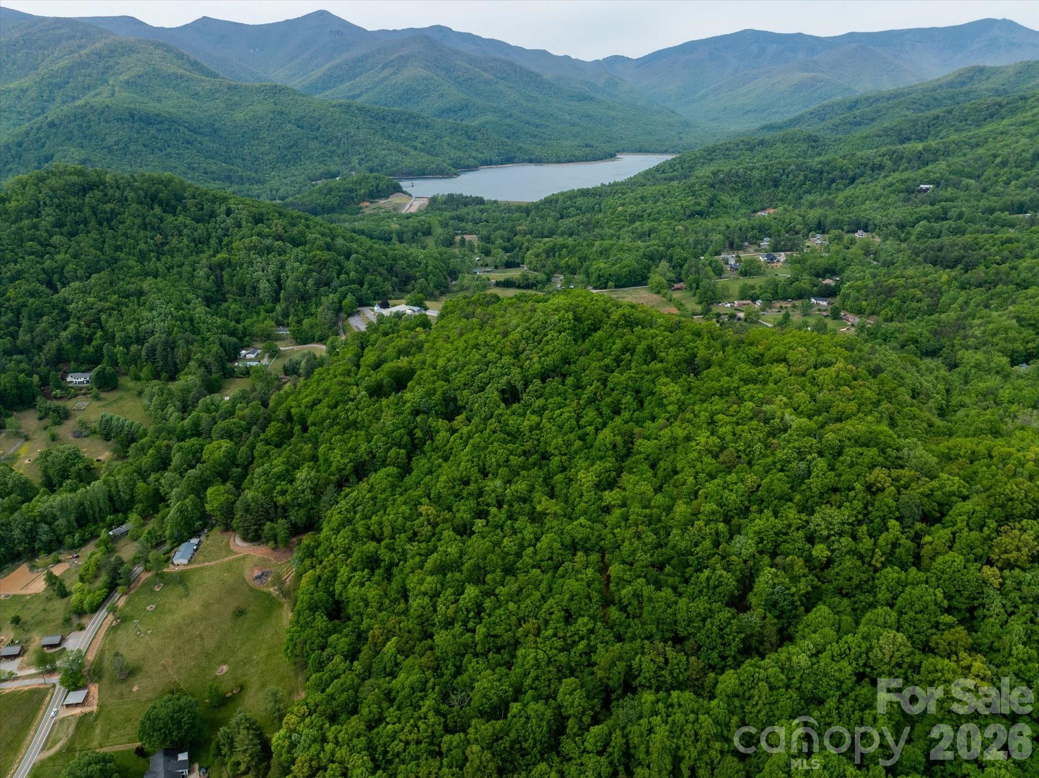 Discover this rare double-lot opportunity in an intimate Black Mountain community—offering 3.57 acres with clear Blue Ridge Mountain views from its elevated perch along the ridgeline at the top of a quiet cul-de-sac. A newly paved road provides smooth access all the way to the property, combining convenience with a private, tucked-away setting among just six total homesites.

Lots 5 and 6 are being sold together, each offering a prime homesite with a workable mountain topography and favorable sunny orientation—ideal for maximizing both build ease and long-range views. The dual-parcel configuration creates added flexibility for those considering investment potential, including short-term rental opportunities, a multi-home setup, or a larger private estate.

Lot 6 features approximately a half-mile of professionally designed walking trails by Long Cane Trails, thoughtfully woven through the landscape and complemented by handcrafted wooden benches—a rare feature that elevates the land beyond a typical homesite and creates a peaceful, wellness-inspired setting right from your doorstep.  

Whether you're envisioning a private mountain retreat, a “resort-at-home” style build, or a strategic investment with two homesites, this property offers a unique blend of versatility, privacy, and natural beauty. Conveniently located less than 10 minutes to downtown Black Mountain and just over 20 minutes to Asheville.