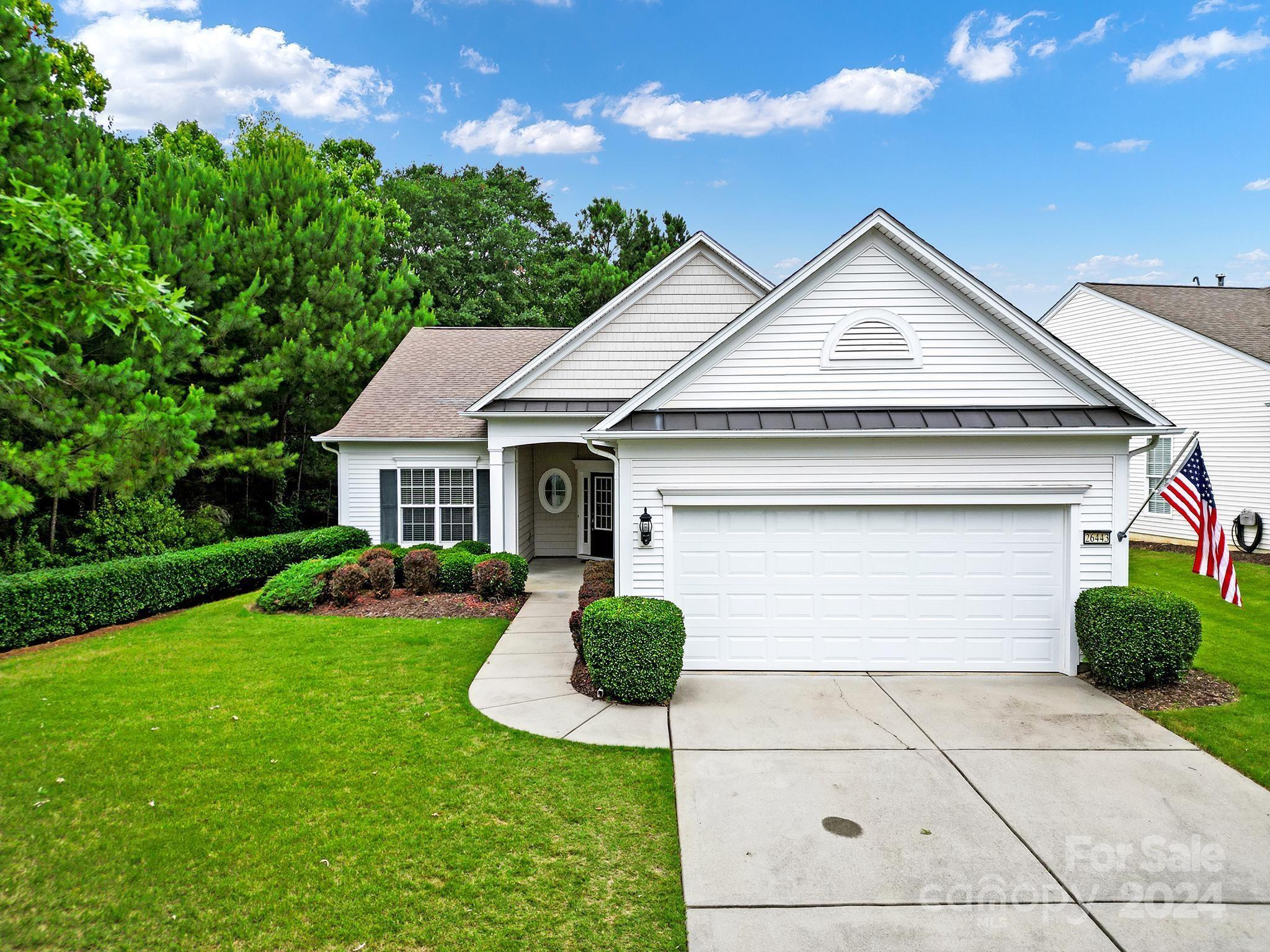 Fabulous opportunity at this popular Surrey Crest home w/ 3-season room & extended deck in amenity-rich Sun City! You'll immediately notice the pastel paint and trim details throughout! Enjoy entertaining in the gourmet eat-in kitchen w/ granite counters, dining nook, & an island w/ bar seating. The pass-through window overlooks the open great room w/ LVP floors & a gas-log fireplace! Spacious primary suite w/ new carpet sits at the back of the home w/ a private bath featuring a dual sink vanity, garden tub, glass shower & a walk-in closet. French doors open to the home office- perfect for working at home! The guest bdrm & full hall bath maximize privacy for both homeowner & guest. You'll love relaxing in the tiled 3-season room overlooking the private backyard w/ pull-down window shades & a ceiling fan. Step out onto the wooden deck to soak up the sun while enjoying the privacy of the adjacent woods! Come experience the resort style amenities in Sun City today!