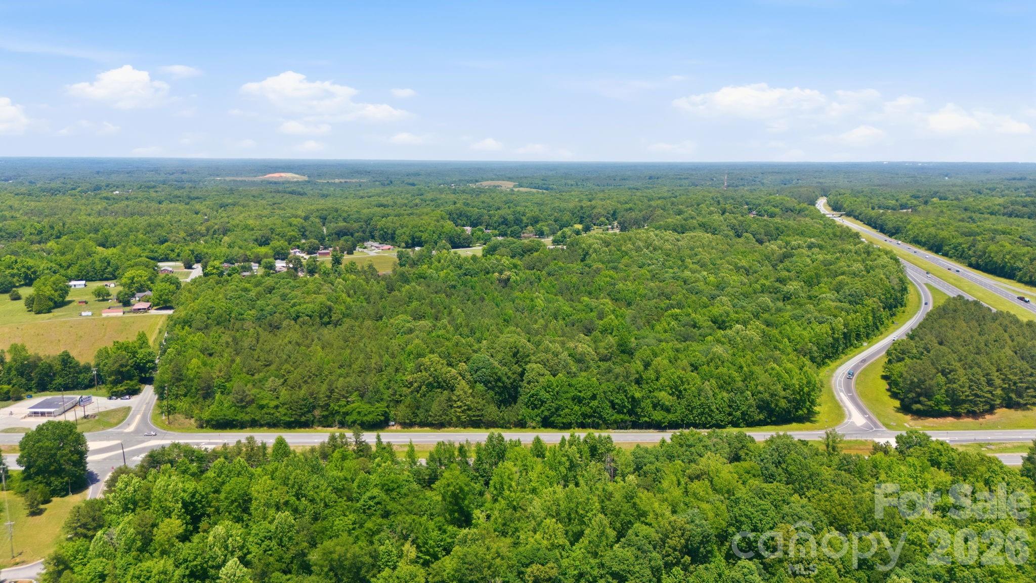 Strategic Development Opportunity in Davidson County
Located along the Highway 64 corridor in Lexington, North Carolina, this ±38-acre tract presents a compelling opportunity for investors, developers, and owner-users seeking a large-scale land position in one of the Triad’s growing secondary markets. The property offers strong accessibility, flexible future development potential, and proximity to major regional employment and transportation corridors.

Property Highlights:
* ±38 Acres of Raw, Undeveloped Land with significant potential under current zoning for retail, shopping, medical, entertainment, storage, or mixed-use development.
* Excellent Highway Access with frontage and visibility along E Highway 64, providing direct connectivity to Lexington, Asheboro, and the greater Piedmont Triad region.
* Strategic Central Location between Charlotte, Greensboro, and Winston-Salem markets.
* Development Flexibility suitable for a wide variety of future uses subject to zoning and municipal approvals.
* Growing Regional Demand driven by continued population growth and industrial expansion throughout Davidson County and surrounding Triad communities.
* Strong Long-Term Appreciation Potential in an expanding logistics and manufacturing corridor.
* Large Contiguous Acreage increasingly difficult to find in Davidson County, creating scarcity value for future development.
* Favorable Topography & Scale offering efficient site planning opportunities for phased development or a single-user campus concept.
* Opportunity Zone for Investors Seeking Land Banking or Future Entitlement Upside.

Location Advantages:
* Convenient access to US Highway 64, a key east-west transportation corridor.
* Within driving distance of major regional employers, manufacturing hubs, and distribution centers.
* Accessible to the broader Piedmont Triad region, including:
   - Greensboro
   - Winston-Salem
   - High Point
   - Asheboro
   - Salisbury
* Positioned within Davidson County, an area experiencing continued residential and commercial growth. Davidson County’s population is estimated at more than 180,000 residents and continues to expand within the greater Triad region. 

Investment Potential:
This property offers investors the opportunity to acquire a sizable land tract with long-term upside in a market benefiting from continued infrastructure investment, industrial growth, and regional migration trends. The combination of highway access, development scale, and location within the expanding Triad corridor positions the site as an attractive candidate for future retail, office, restaurant, medical, storage, recreational, or mixed-use projects.