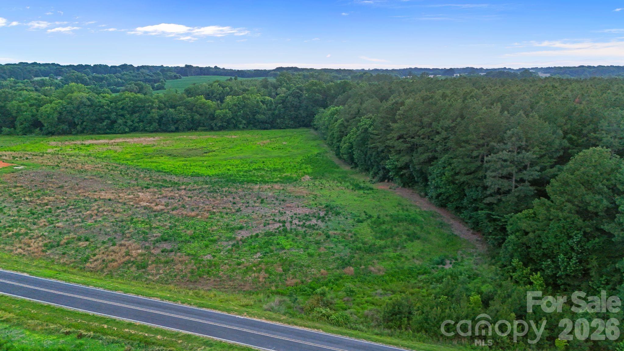 13.83 Acres of Prime Countryside in Highly Desired Marshville, Union County!

This exceptional homestead offers the perfect blend of privacy and convenience, with sweeping long-range farm views and a peaceful country lifestyle not far from Charlotte, New Salem, and Monroe. Whether you're looking to escape the hustle of city life or simply plant roots in a place that feels like home, this property delivers the space, serenity, and versatility that's increasingly hard to find. At the rear of the property, Salem Creek winds its way through the landscape, adding a diverse natural element that's perfect for wildlife habitat and outdoor recreation. From morning deer sightings to afternoon sunsets, the land invites you to slow down and connect with nature right in your own backyard.

The possibilities here are truly endless. Build your forever home, launch a thriving hobby farm, create a multigenerational family compound, or simply enjoy the peace and open space this remarkable parcel provides. RA40 zoning offers flexibility for both residential and agricultural use, giving you the freedom to bring your vision to life. A preliminary soil examination has already been completed for septic system feasibility, saving you time and giving you confidence as you plan your next steps.

Hundreds of feet of road frontage and electrical utilities already available make this an ideal homesite for your custom dream home. You'll enjoy easy access to grocery stores, gas stations, and modern amenities — all while living the quiet rural life you've been dreaming of. And if recreation is on your mind, Eagle Chase Golf Club is just down the street.

The majority of the land is comprised of open fields, ready and waiting for farming, gardening, or equestrian use. Whether you envision raised garden beds, row crops, a horse pasture, or simply wide open space to roam, this land is ready to work for you. Bordering the fields, 5+ acres of mixed hardwood timber create a stunning scenic backdrop and a natural privacy buffer that provides both beauty and seclusion throughout every season.

Additional acreage may be available for purchase — inquire for details and make this slice of Union County your own.

Don't miss this rare opportunity to own a substantial, versatile parcel in one of Union County's most desirable rural settings. Properties like this don't come around often — schedule your showing today!