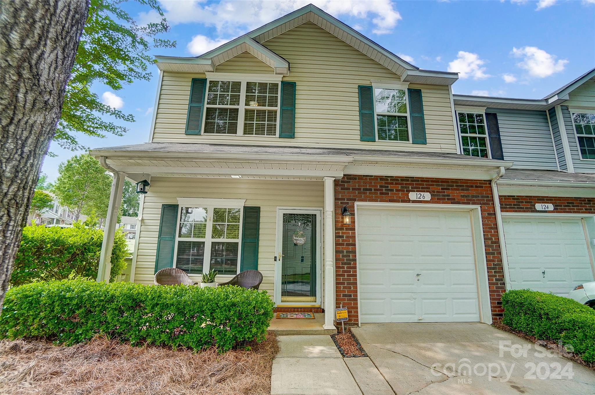 Beautiful end unit with a 1 car garage; across the street from the pool.  Open floor plan on the main level, plenty of kitchen cabinets and counter tops. Refrigerator, dishwasher and range replaced in 2020. Crown molding throughout the downstairs and primary bedroom. Spacious primary bedroom with large walk-in closet and en-suite bathroom.  Upstairs has 2 bedrooms, 2 bathrooms, loft area, and flex room/office. Secondary bathroom upstairs was remodeled in 2022 with beautiful new tile flooring and tile surround. Additional parking space purchased until May 2025. HOA covers water bill, trash pickup, lawn care, exterminating, roof and exterior maintenance. Great location in Fort Mill close to shopping, restaurants and I-77. Move in ready!