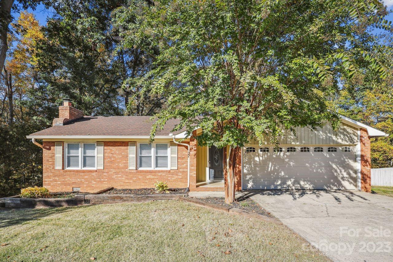 Brick ranch on over half an acre, cul-de-sac lot in desirable East Iredell! Upon entering this lovely home you'll find a  large great room with a gorgeous brick fireplace, which opens up to a large dining room. The beautiful kitchen is loaded with ample cabinetry and flows nicely into the dining and great rooms for easy entertaining. Split floor plan includes a primary suite and two additional secondary bedrooms. Fresh paint throughout. Relax on the large deck out back while enjoying the private, tree filled backyard. Convenient to shopping, restaurants, Lake Norman and several parks. Easy access to I-77 and I-40.