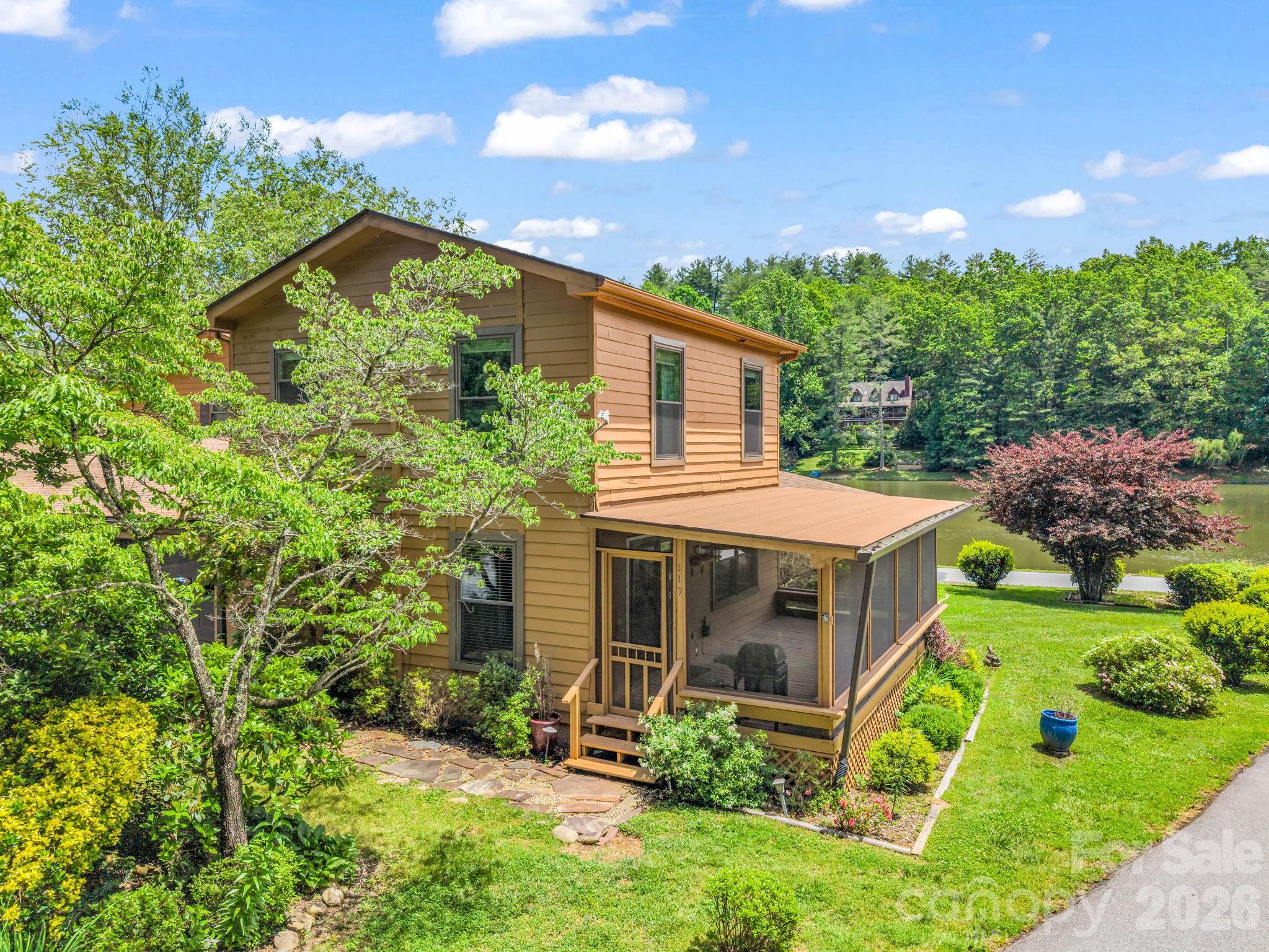 Tucked away in one of Hendersonville’s hidden gem communities, this charming lake-view retreat offers the perfect blend of mountain serenity, affordability, and investment potential. With water views at a price point well below the county average, 117 Willow Way is the opportunity buyers have been waiting for. Whether you’re searching for a vacation getaway, second home, short-term rental, or income-producing investment property, this one checks all the boxes.

This inviting 2-bedroom, 1-bath home features thoughtful updates throughout, including a newer roof (1.5 years old), updated HVAC mini-splits (5 years), and newer windows (3 years), giving peace of mind for years to come. The kitchen has been refreshed with updated countertops, backsplash, stove, and newer refrigerator, while the bathrooms have seen tasteful improvements including new flooring and upgraded finishes upstairs. Encapsulation adds additional value and efficiency.

The true showstopper is the screened-in porch overlooking the lake — the perfect place to enjoy morning coffee, unwind after a day exploring Western North Carolina, or simply soak in the peaceful surroundings. Nestled in a quiet, private setting with lake views and year-round enjoyment, this property offers the mountain lifestyle buyers crave without the premium price tag.

Conveniently located near Hendersonville’s vibrant downtown, outdoor recreation, hiking, breweries, and everything Western North Carolina has to offer, this property presents incredible flexibility for personal enjoyment or rental income potential.

Affordable lake-view opportunities in Henderson County are rare — schedule your showing today before this hidden gem is gone!