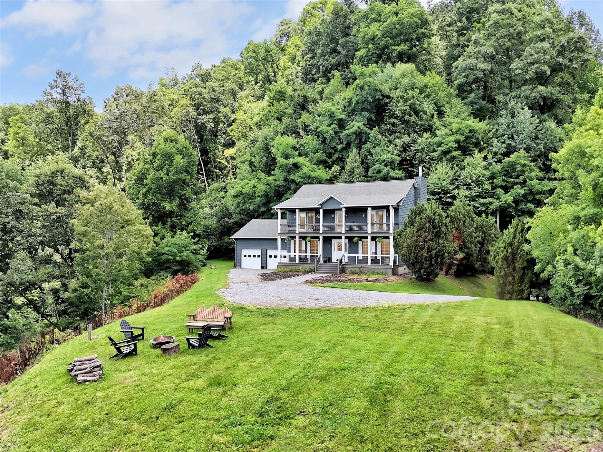 Experience mountain living at its finest in this stunning 4-bedroom, 2.5-bath cedar home, perfectly positioned on a private knoll in Haywood County. With a south-facing orientation, this home is flooded with natural light and features sweeping, year-round, long-range views of the Blue Ridge Mountains from almost every room. Designed for both relaxation and entertaining, the open-concept main level centers around a cozy fireplace and flows seamlessly into a chef-ready kitchen, complete with a large island and breakfast bar. The expansive primary suite offers a true retreat, while the additional bedrooms provide flexible space for guests or a home office. Step outside to the double-covered front deck—the ultimate spot for morning coffee or sunset cocktails while taking in the panoramic vistas. Situated within a secure gated community, this property combines exclusivity, durability, and natural beauty. Whether you’re looking for a peaceful year-round residence or a scenic mountain escape, this home delivers an extraordinary lifestyle. While this home offers a quiet escape, you are just a short drive from the convenience of I-40, making travel to Tennessee or Waynesville effortless. Outdoor enthusiasts will love the 'local’s entrance' to the Great Smoky Mountains National Park via the Cataloochee Valley—famous for its stunning wildlife, historic homesteads, and hiking trails, all without the tourist crowds. Whether you're heading out for a day of adventure or into downtown Waynesville for dinner, this home positions you perfectly to enjoy the very best of Western North Carolina.